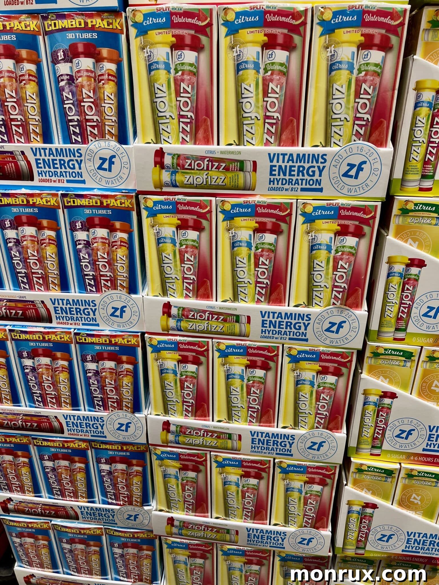 A large stack of Zipfizz energy drink tubes displayed prominently in a Costco store aisle, ready for bulk purchase.