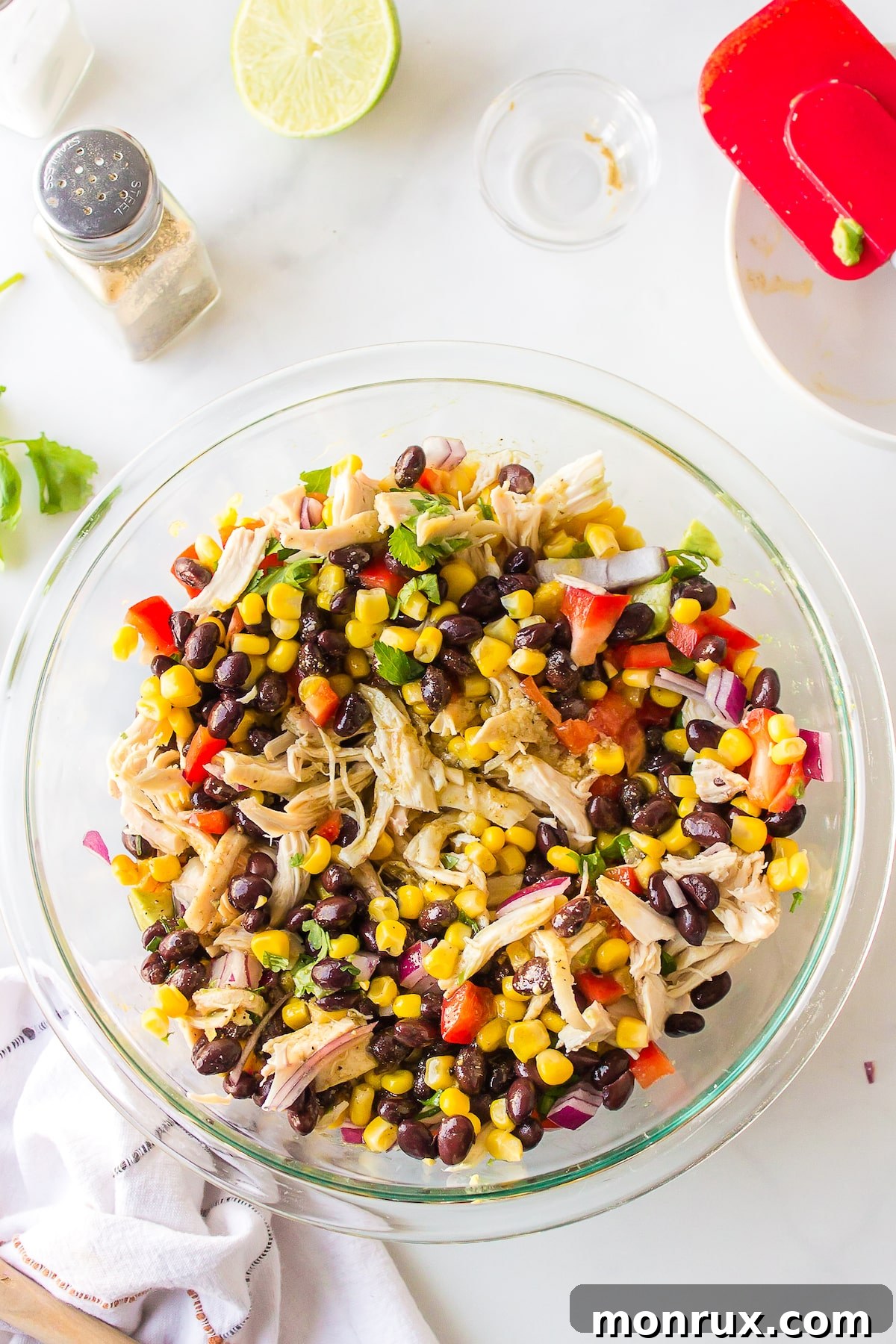 Southwestern salad ingredients thoroughly tossed with the dressing, ready to be served.