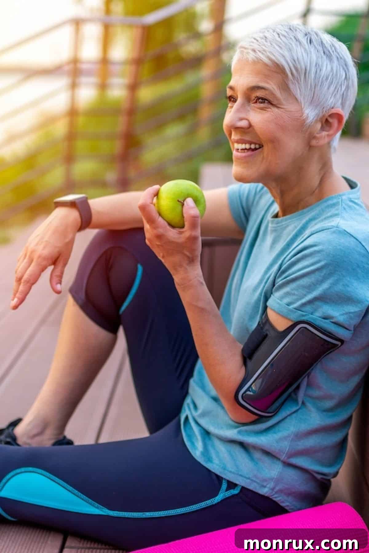 Healthy older woman sitting on deck with an apple, symbolizing vitality and natural health.