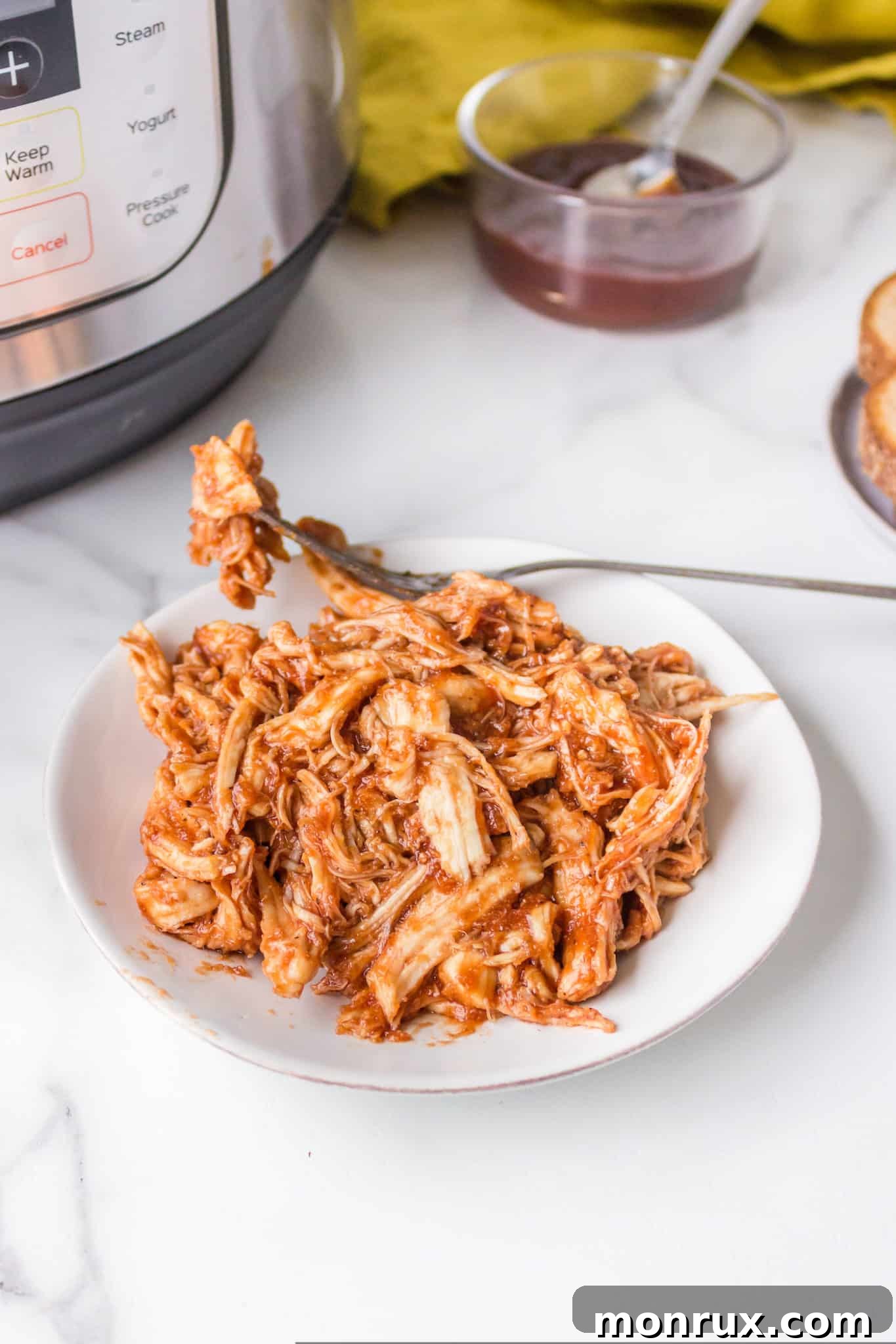 Instant Pot BBQ pulled chicken on a plate, ready to be served.