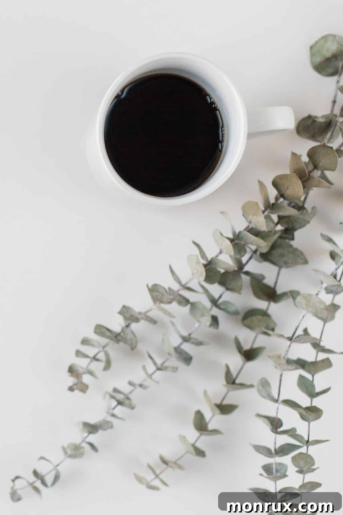 coffee in a white mug on a table.