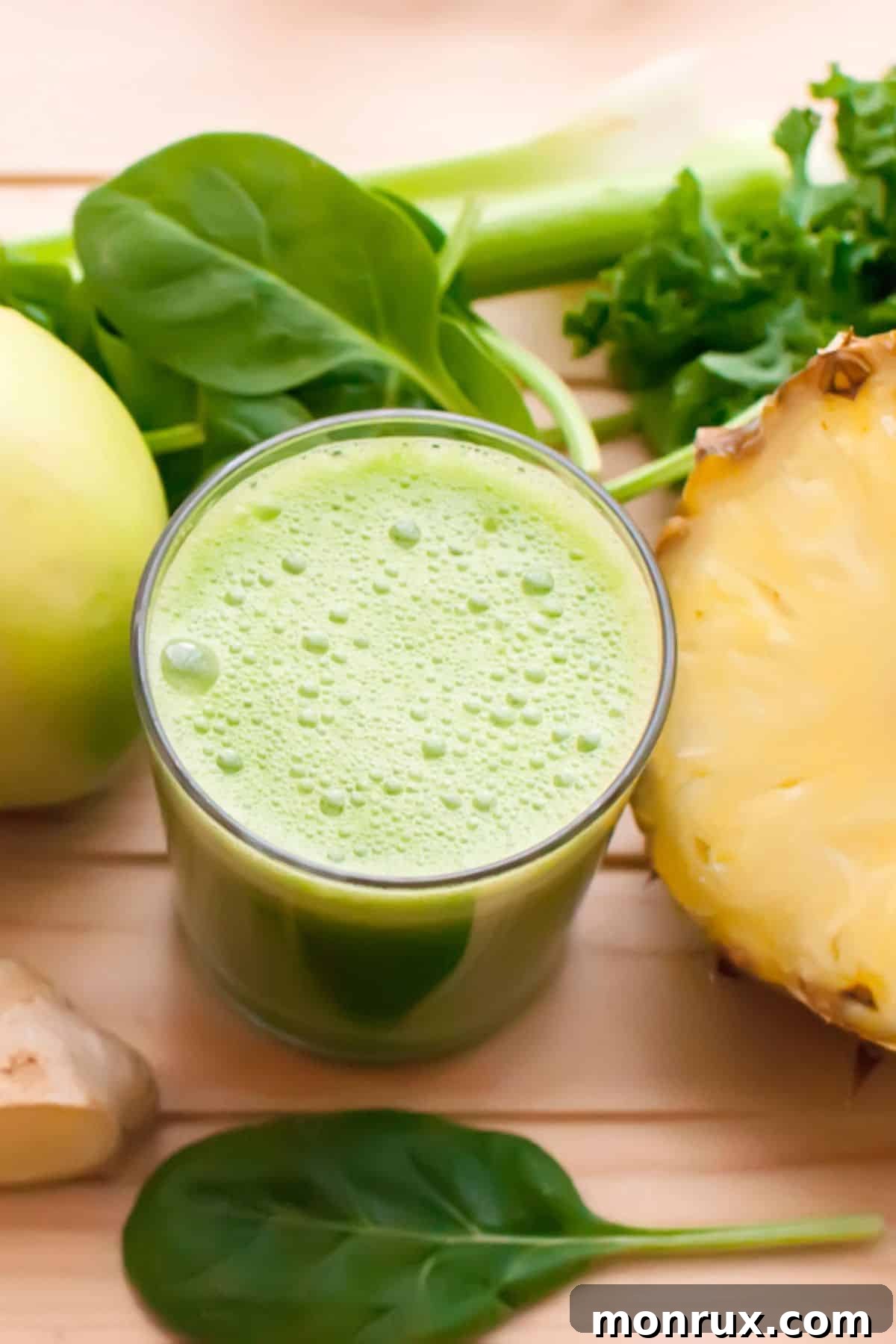 Freshly prepared anti-inflammatory juice on a wooden table, surrounded by its vibrant ingredients like turmeric, ginger, and pineapple.
