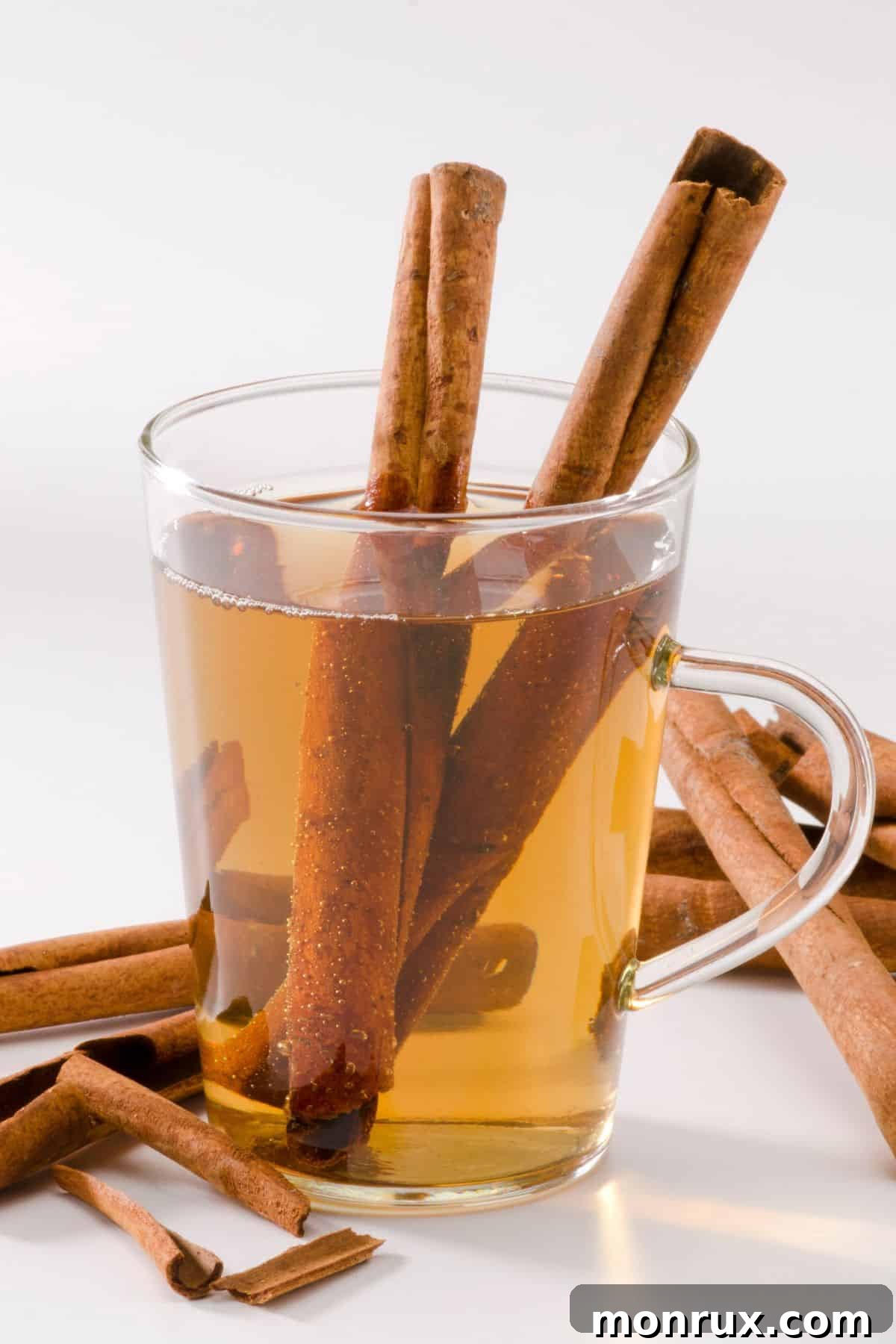 cinnamon tea in a cup with two cinnamon sticks.