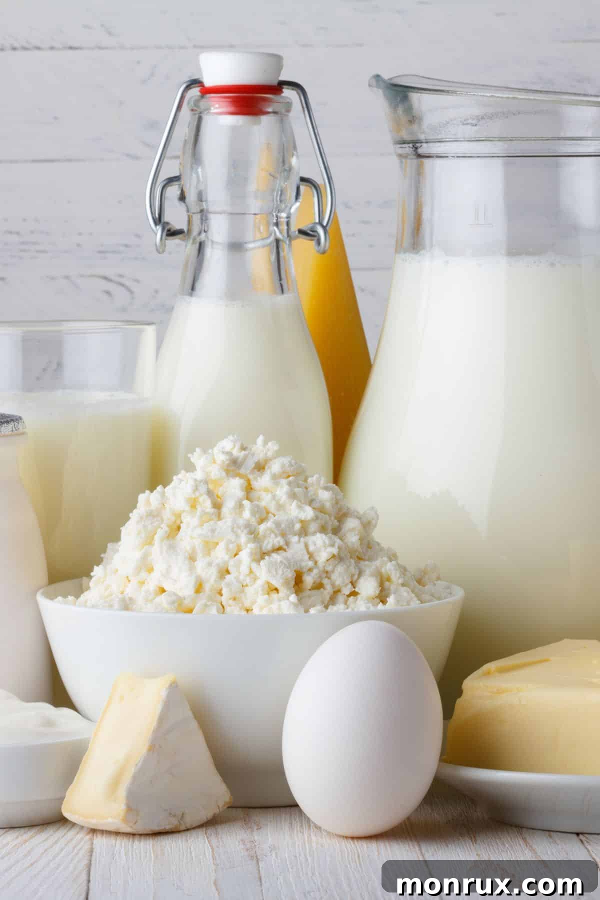 A diverse selection of dairy products including milk, cheese, and yogurt, visually representing the topic of dairy consumption.