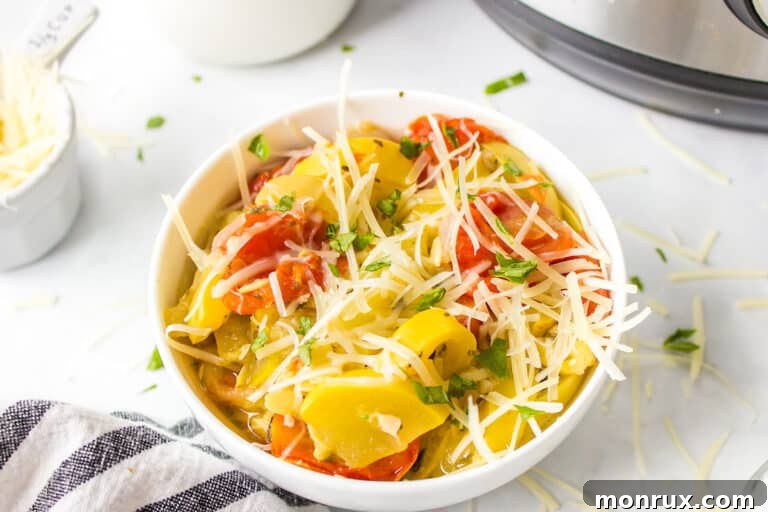 A vibrant bowl of Instant Pot yellow squash and tomatoes, garnished with fresh basil.