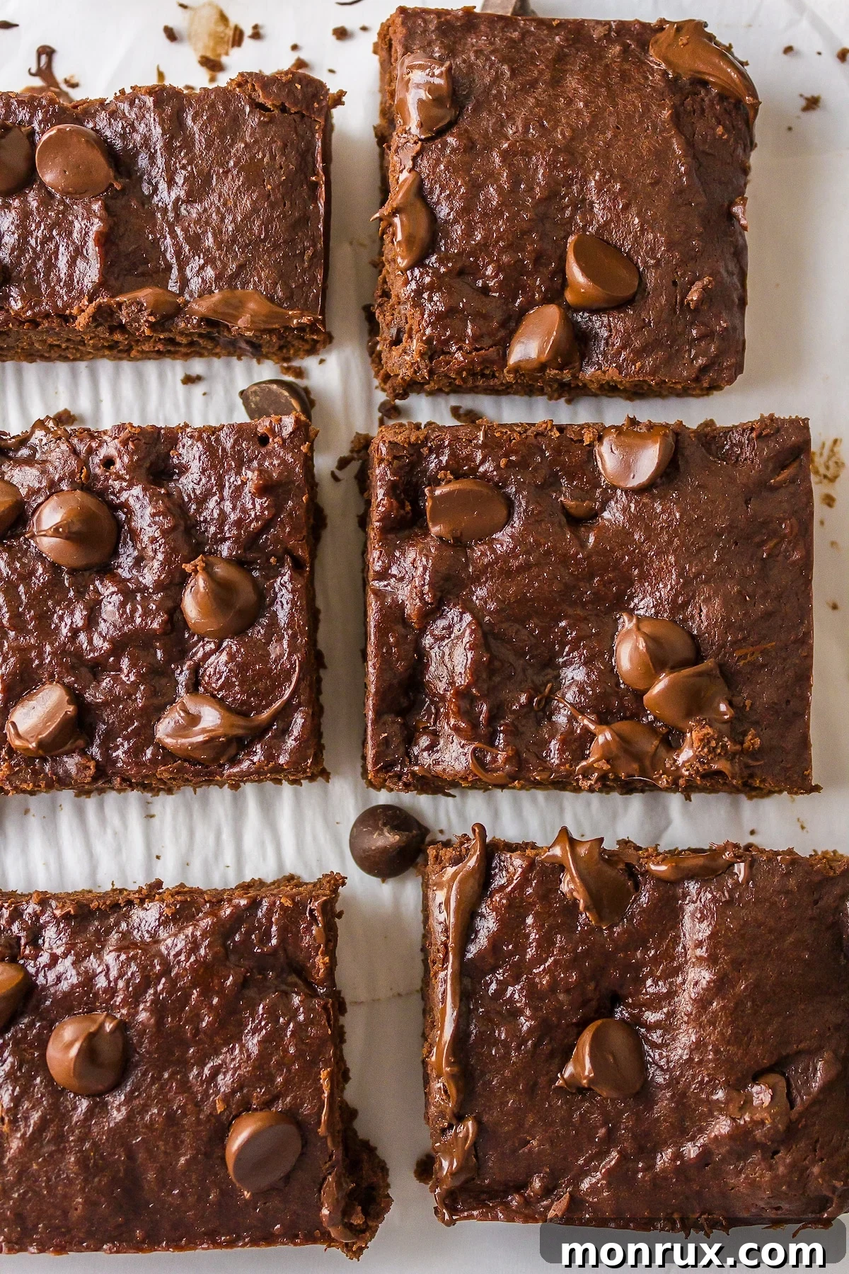 Freshly baked dairy-free brownies cooling on parchment paper, showcasing their rich, fudgy texture and dark chocolate color, perfect for an allergy-friendly dessert.
