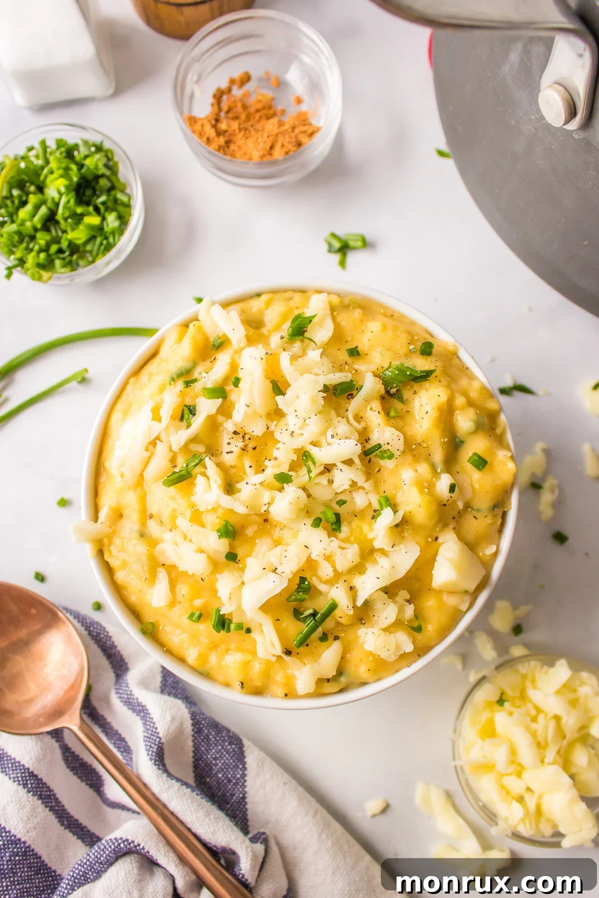 A beautifully presented bowl of creamy Mexican mashed potatoes, garnished with fresh herbs.