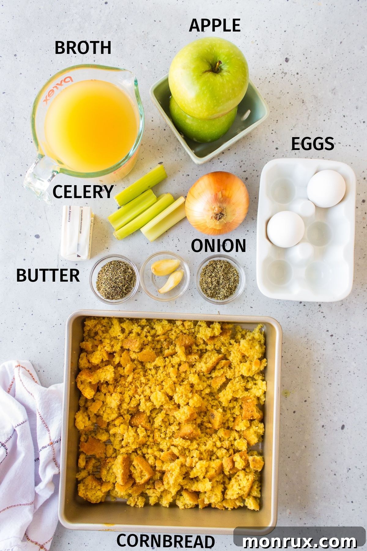 Fresh ingredients for gluten-free cornbread stuffing laid out on a kitchen counter.