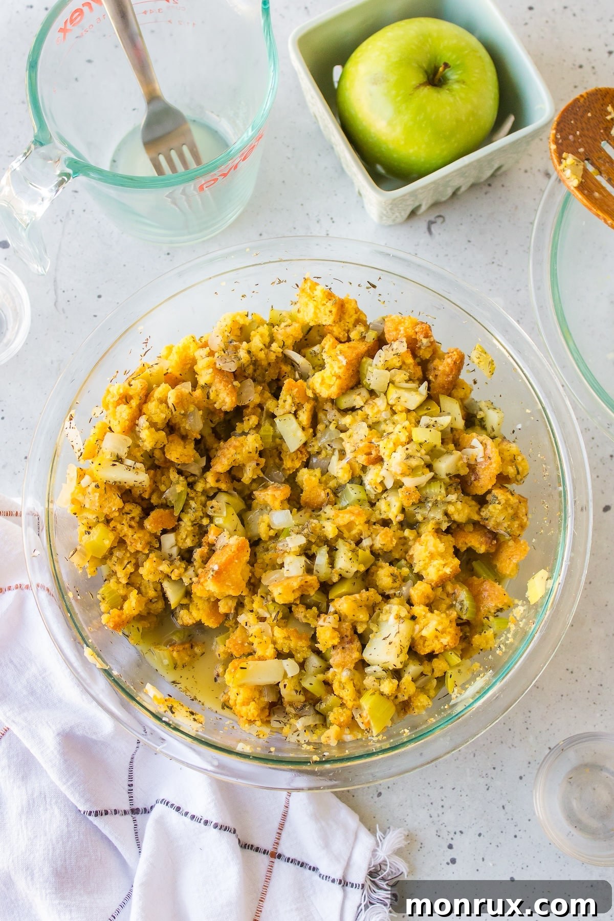 Prepared cornbread stuffing mixture in a large bowl, ready for baking.