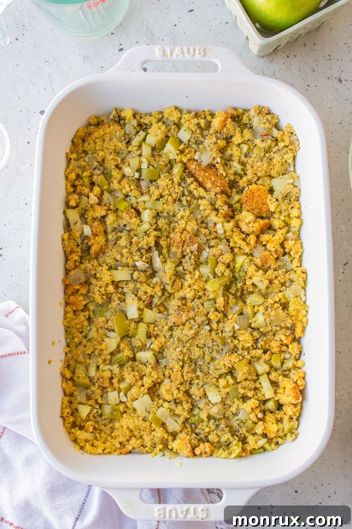 Gluten-free cornbread stuffing mixture transferred to a baking dish, ready for the oven.