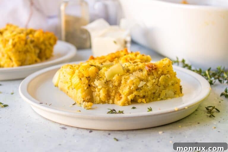 A slice of gluten-free cornbread stuffing on a white plate, ready to be served.