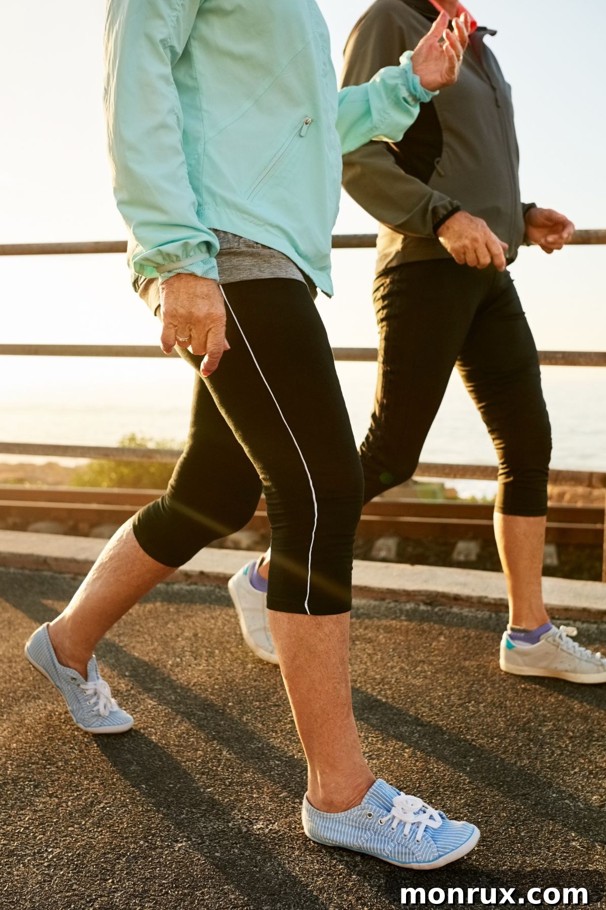 two women walking on a bridge.