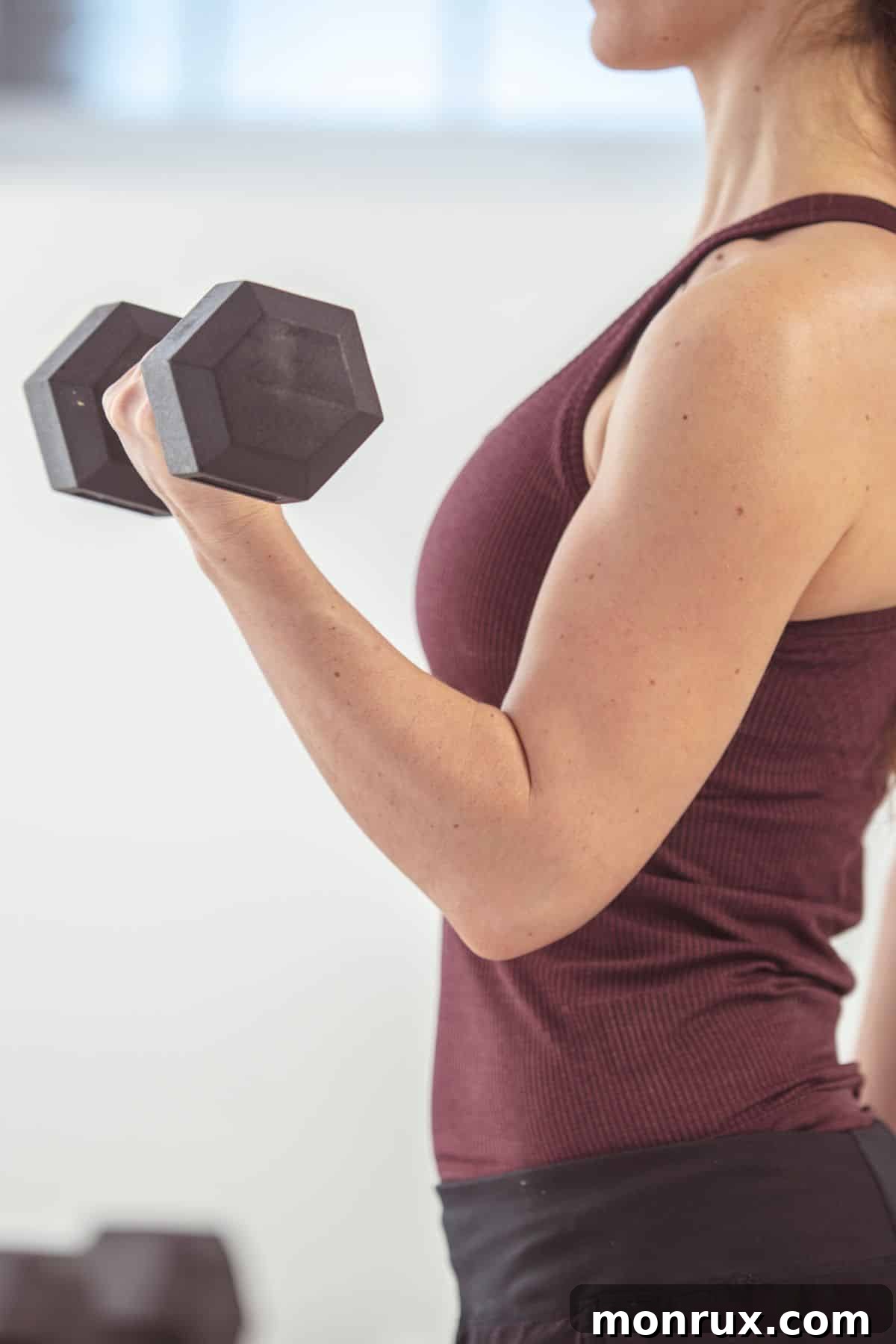 a woman doing a bicep curl.