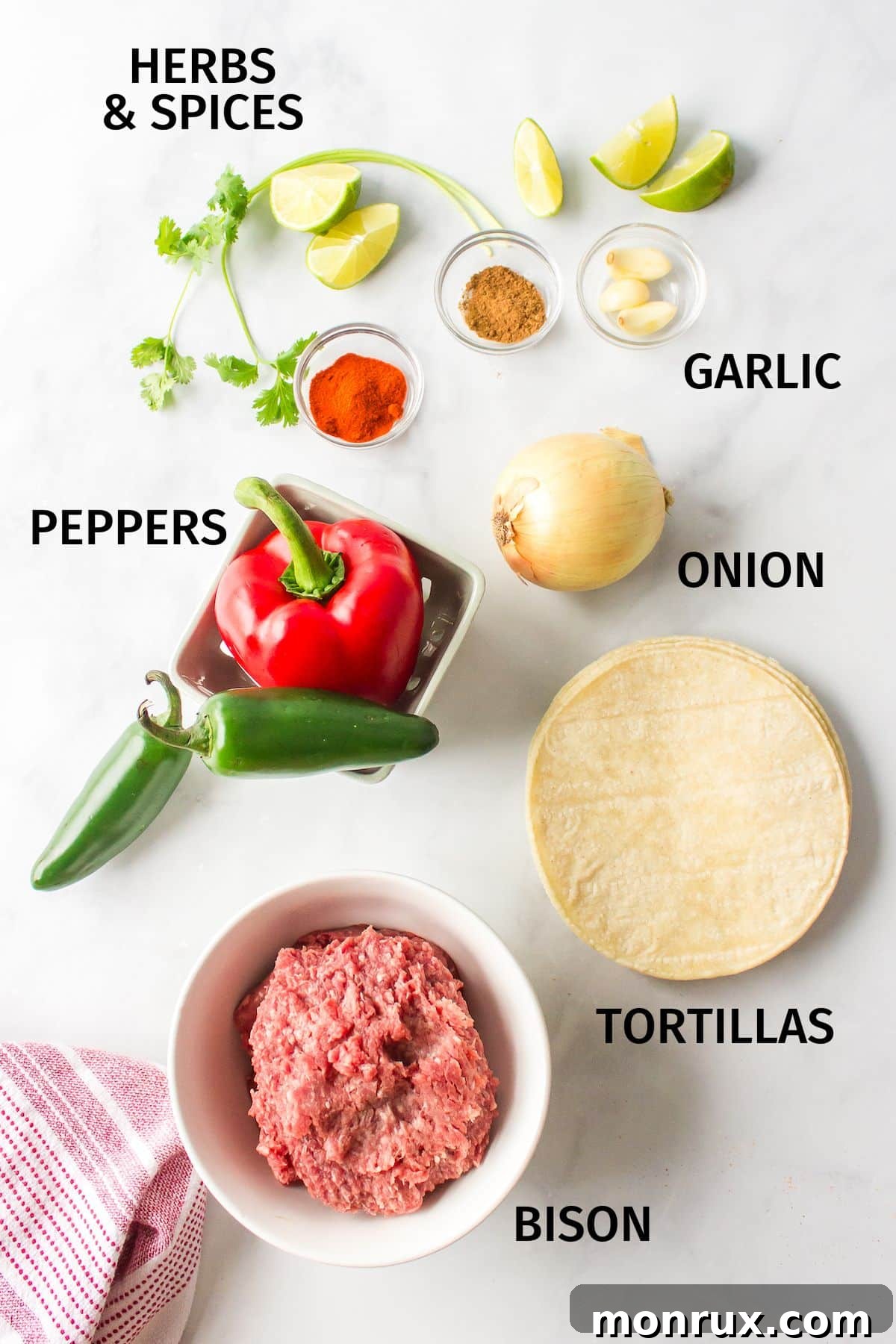 ingredients for ground bison tacos on a counter, including ground bison, vegetables, and seasonings.