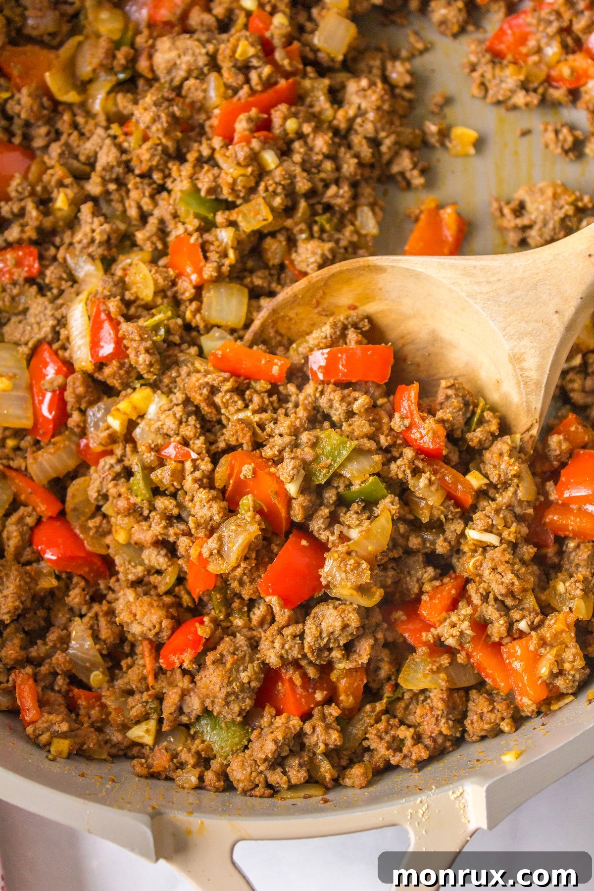 a close up of cooked ground bison meat with spices in a skillet.