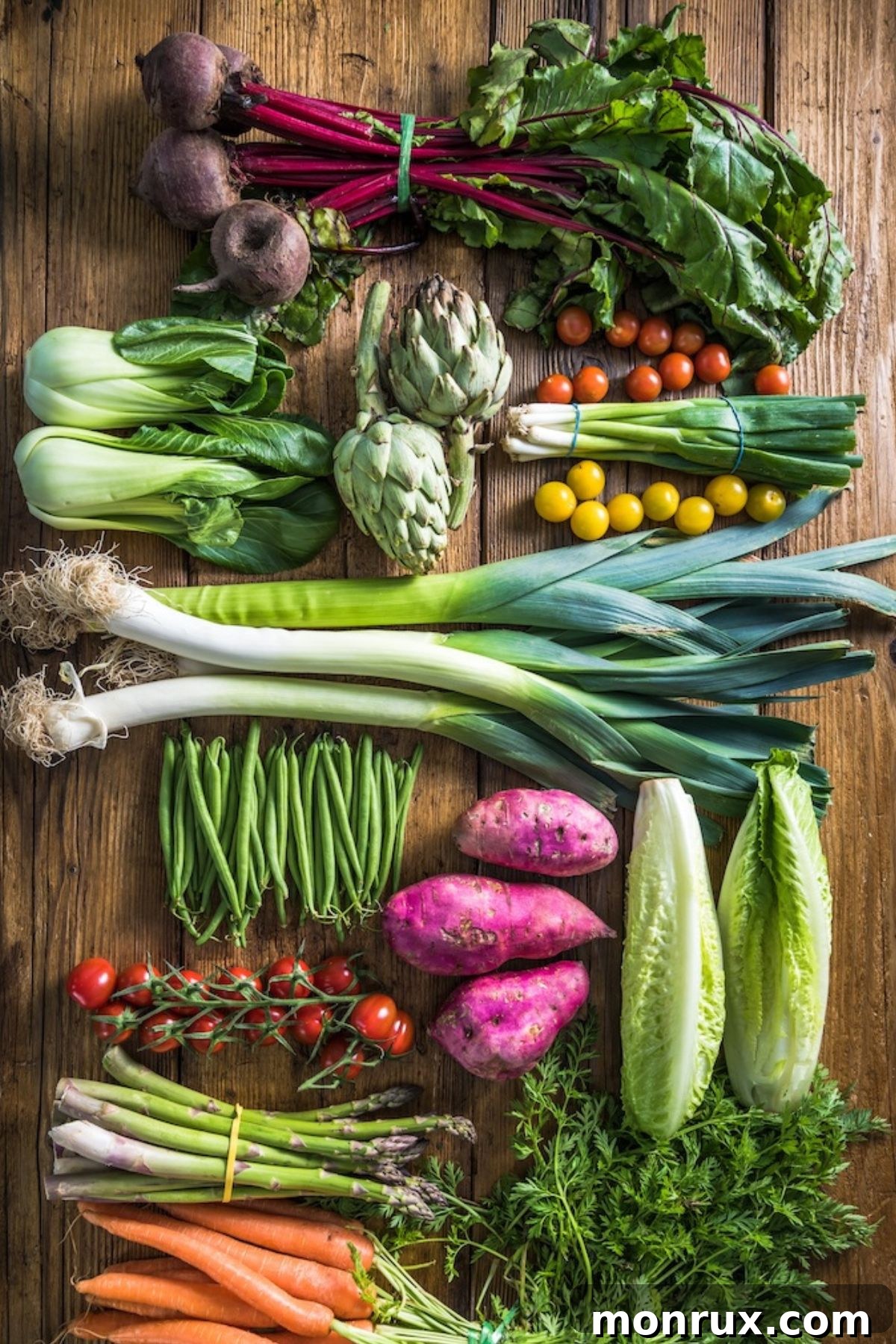 A vibrant selection of fresh vegetables artfully arranged on a rustic wooden table, showcasing a rich palette of natural colors.