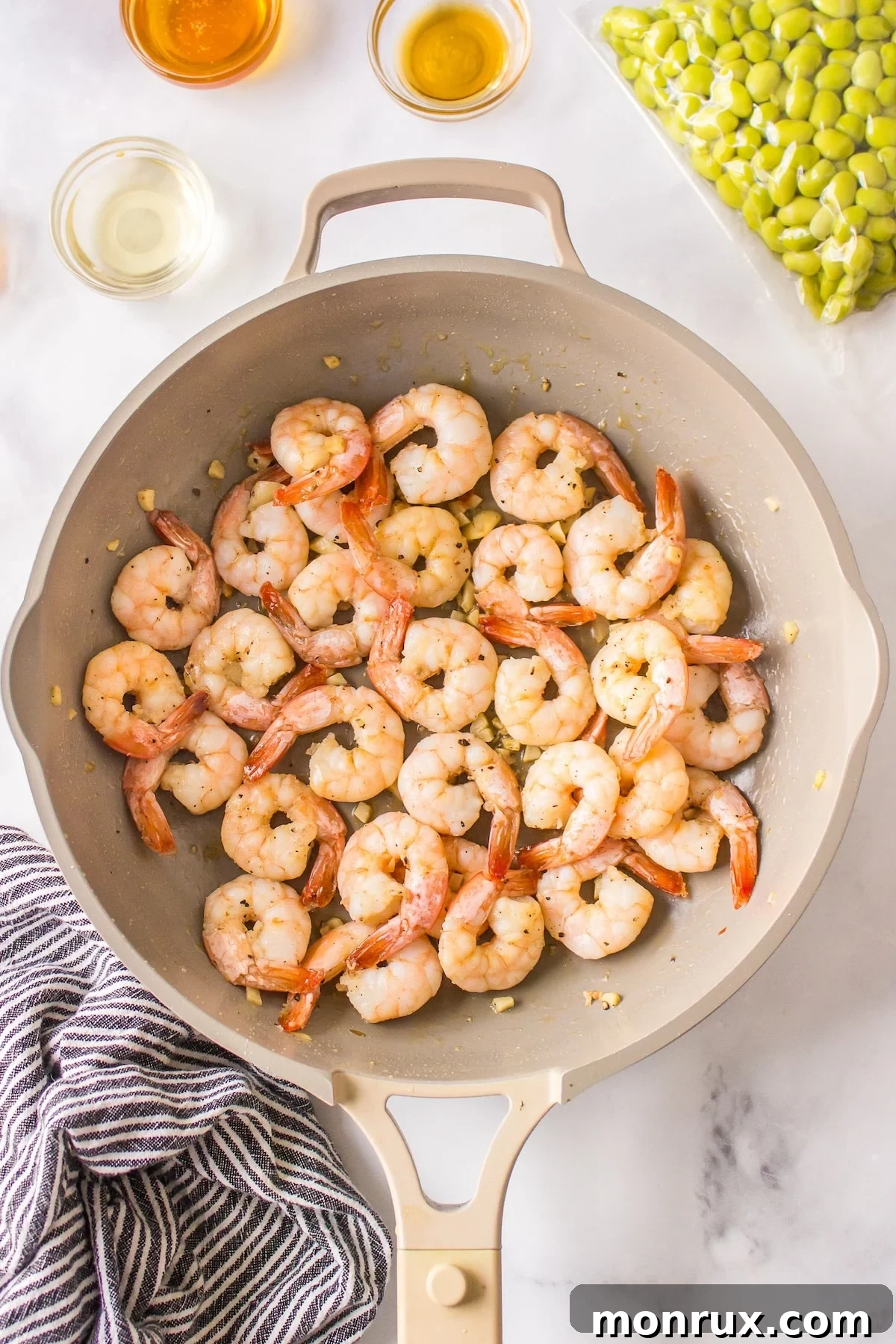 Shrimp cooking to a perfect pink in a hot skillet.