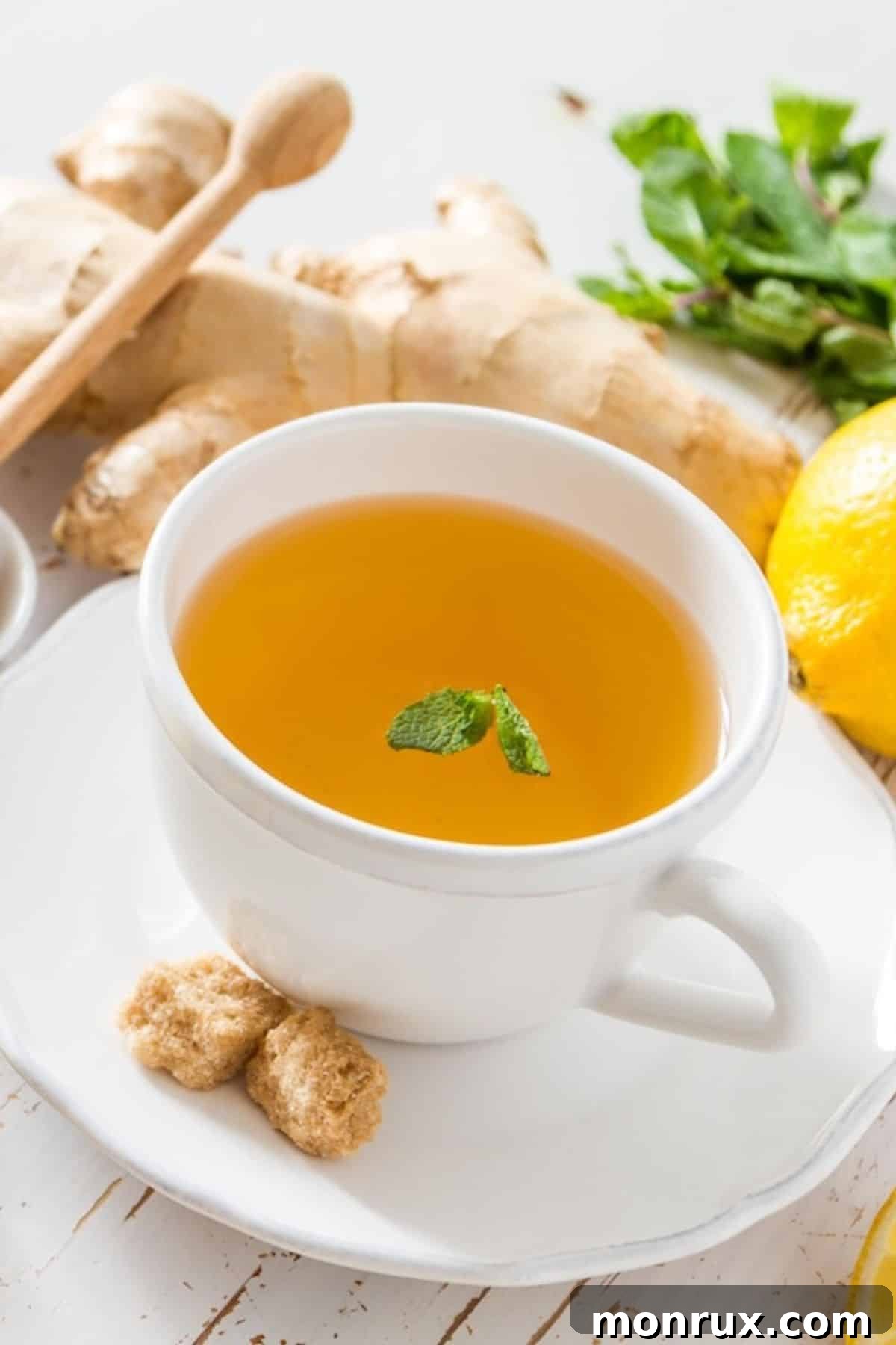 A comforting mug of homemade detox tea, featuring fresh ginger, lemon slices, and a warm, inviting color, perfect for boosting wellness.