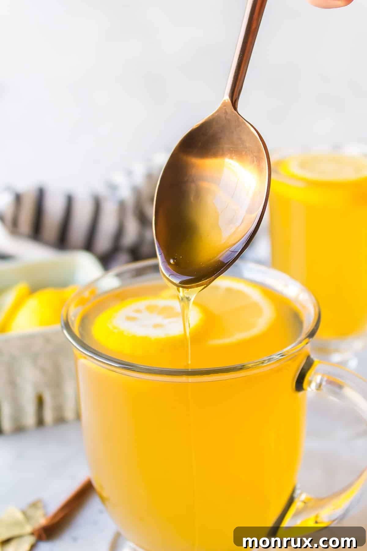 a spoon dipped into a glass of tea.