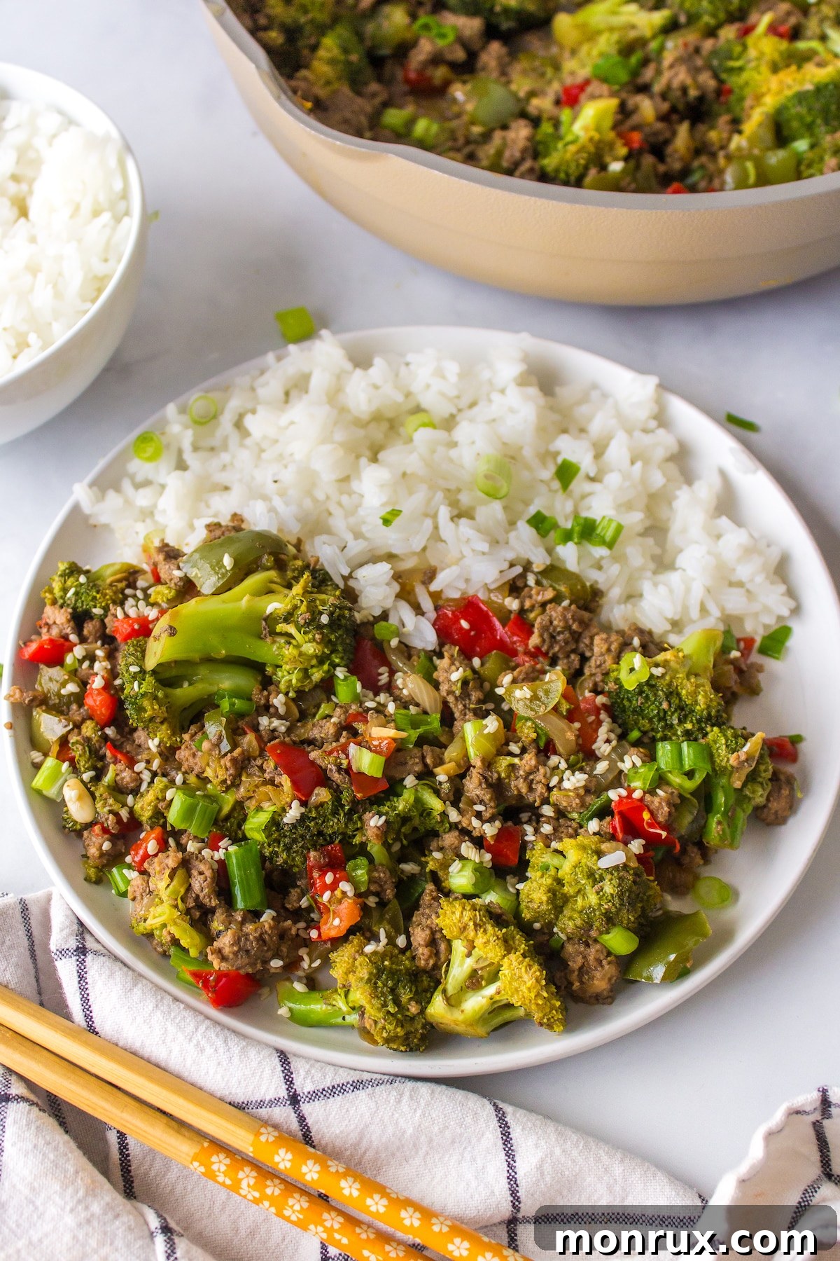 A vibrant plate of ground bison stir-fry served with fluffy white rice, ready to be enjoyed.