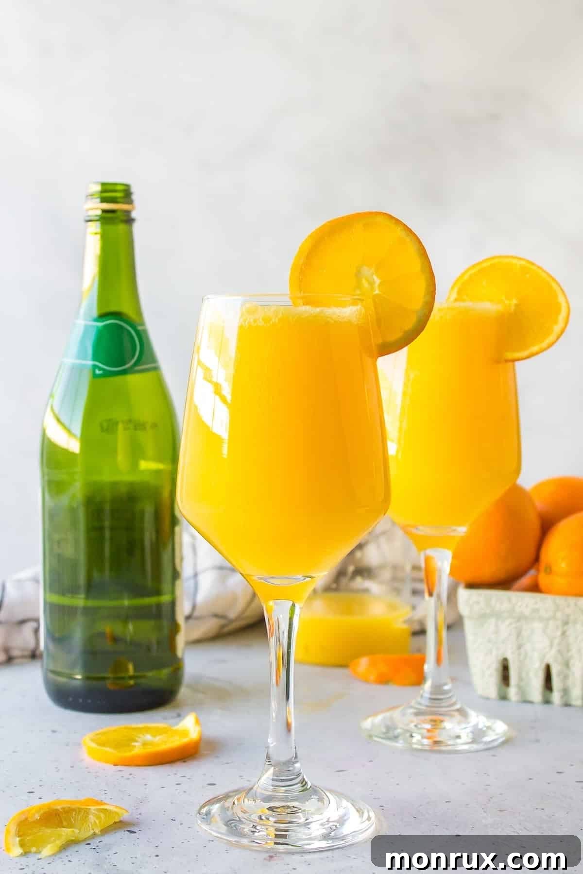 Two glasses of sparkling mimosa mocktails, perfectly garnished and ready to be enjoyed, adding a festive touch to any setting.