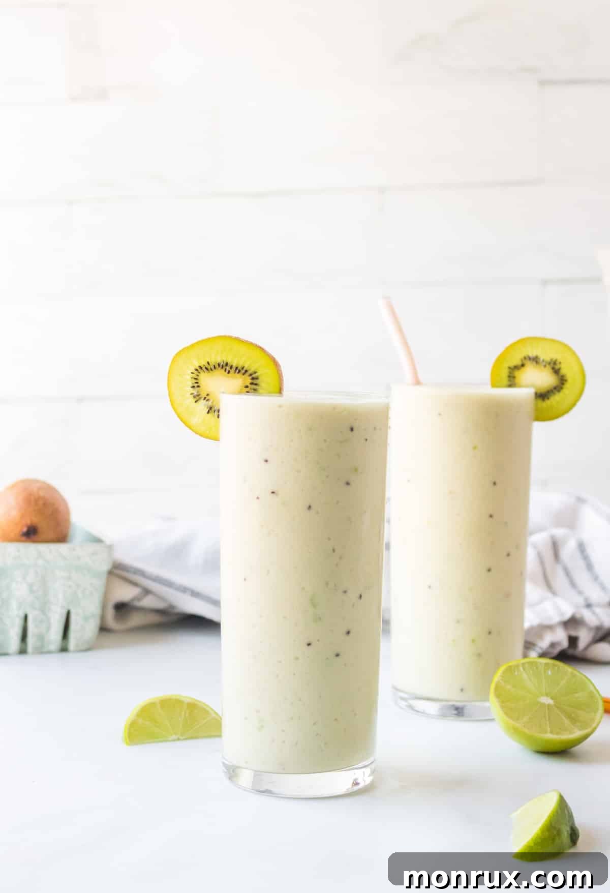 Gut Health Smoothie in glasses with slices of kiwi.