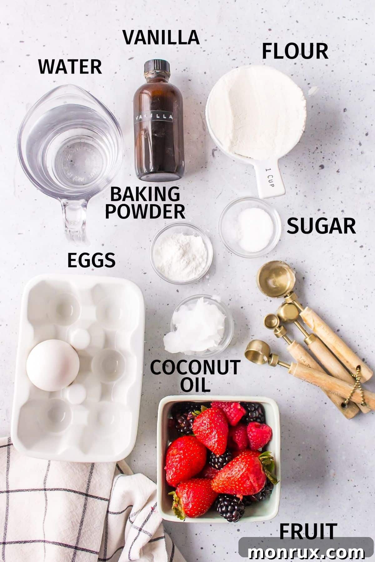 A collection of fresh ingredients laid out on a clean white countertop, ready to be transformed into delicious pancakes without milk. The simple components highlight the accessibility of this recipe.