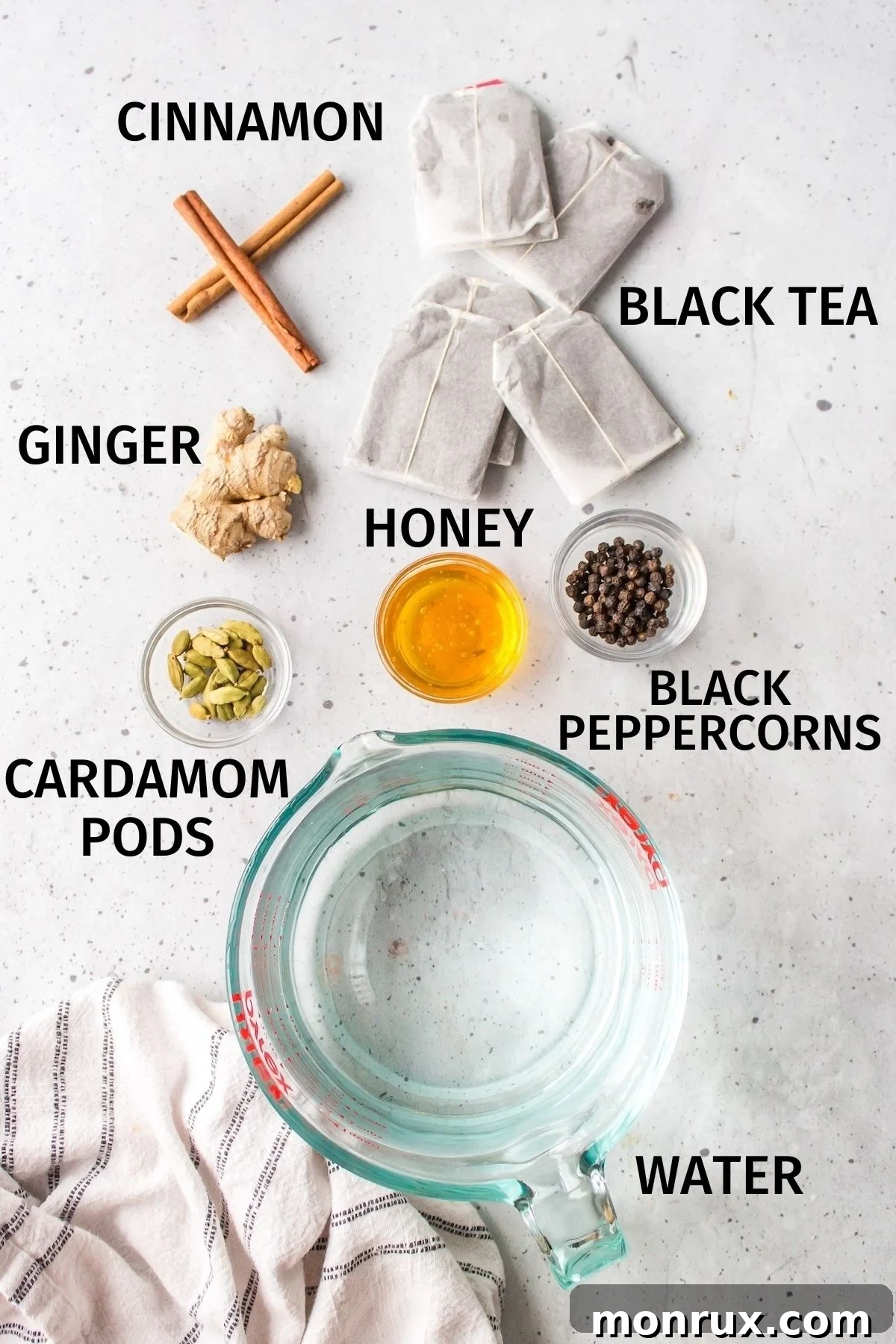 ingredients for chai tea concentrate on a white counter.