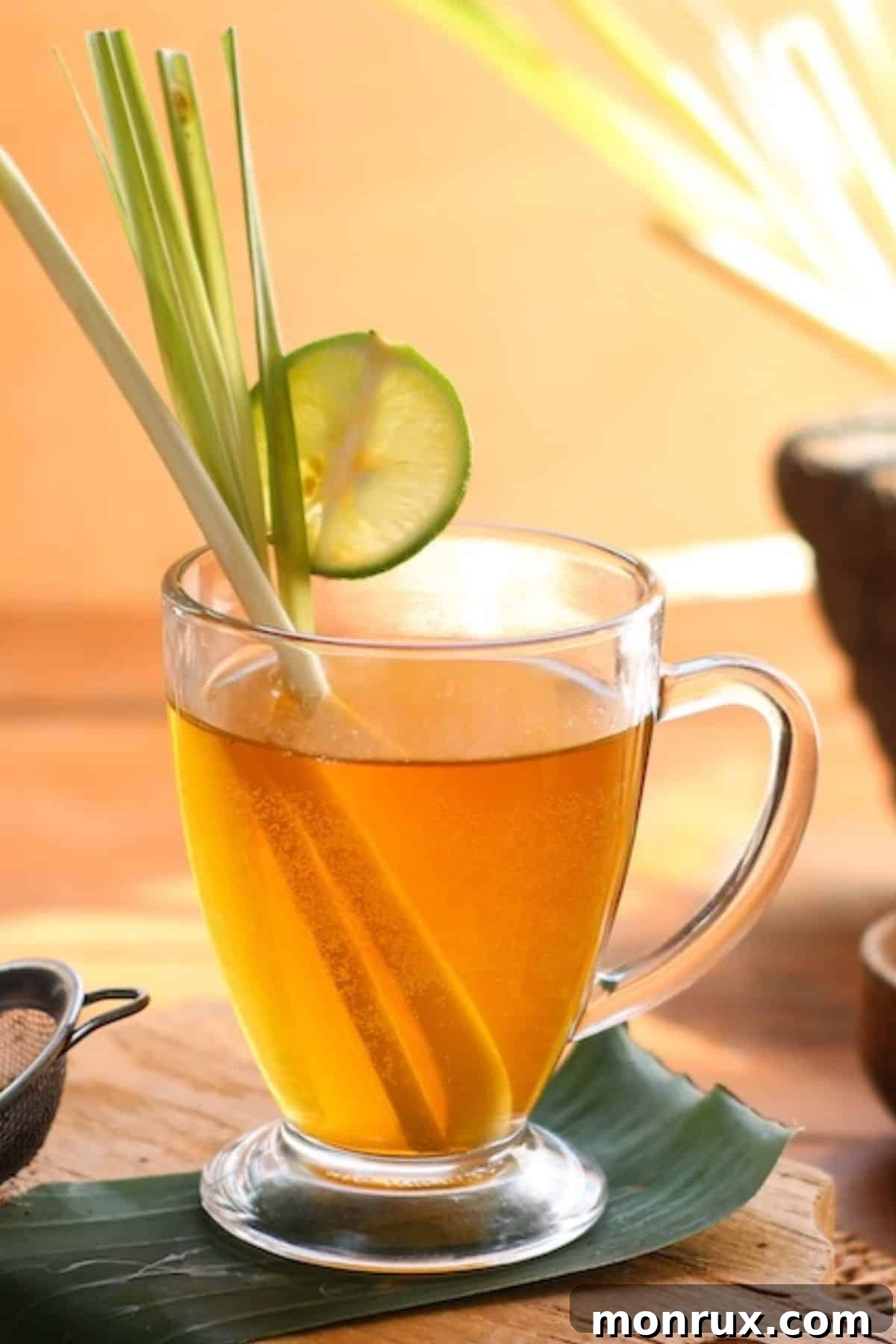 A close-up of a steaming glass of hot lemongrass tea, ready to be enjoyed.