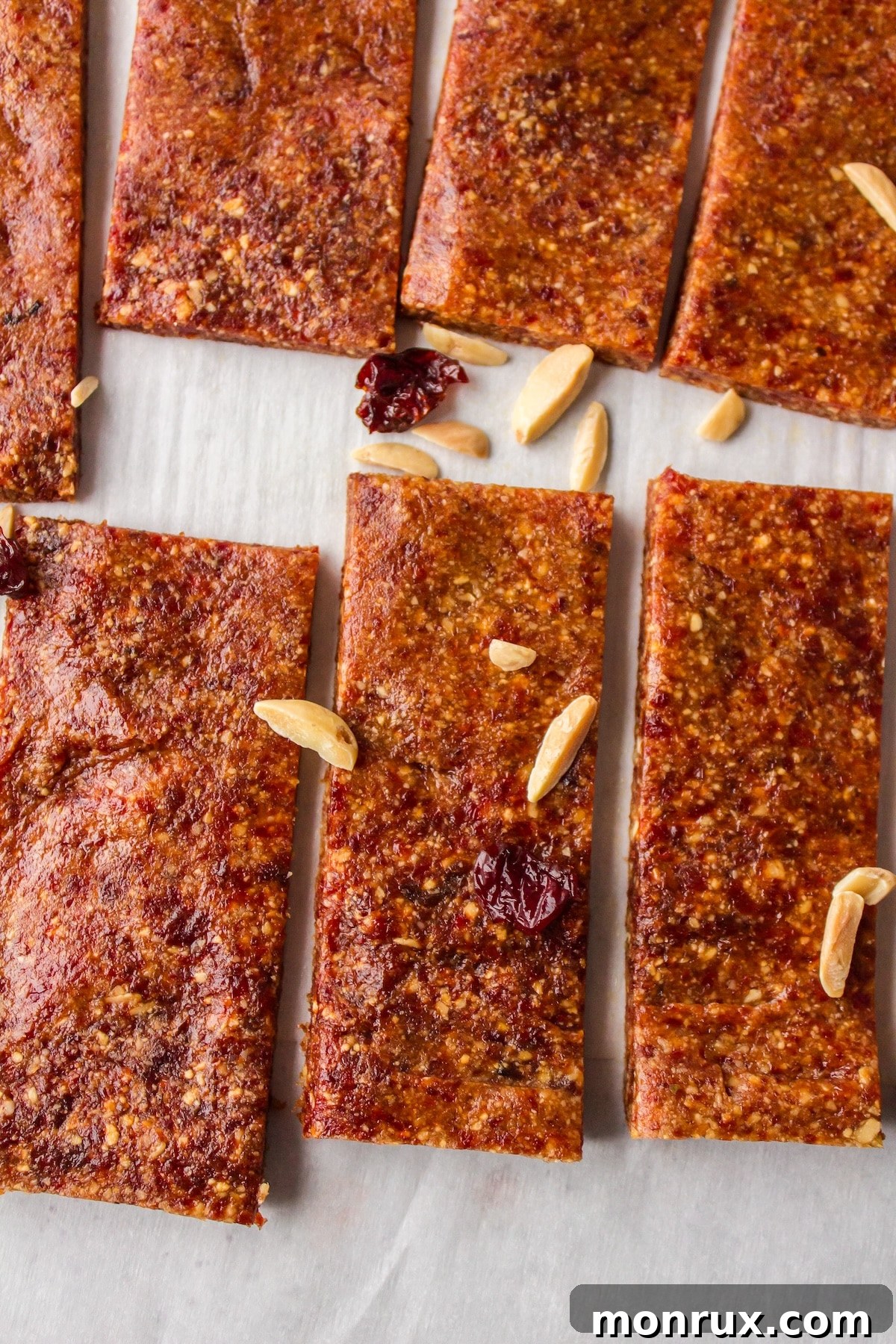 A close-up view of perfectly sliced almond cherry bars, showcasing their dense, chewy texture.