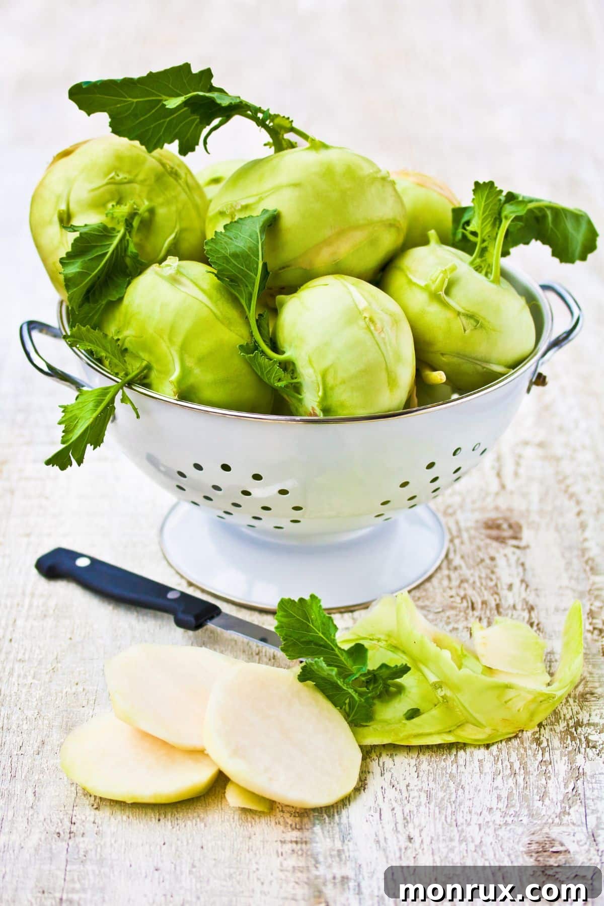 Fresh kohlrabi bulbs in a colander.