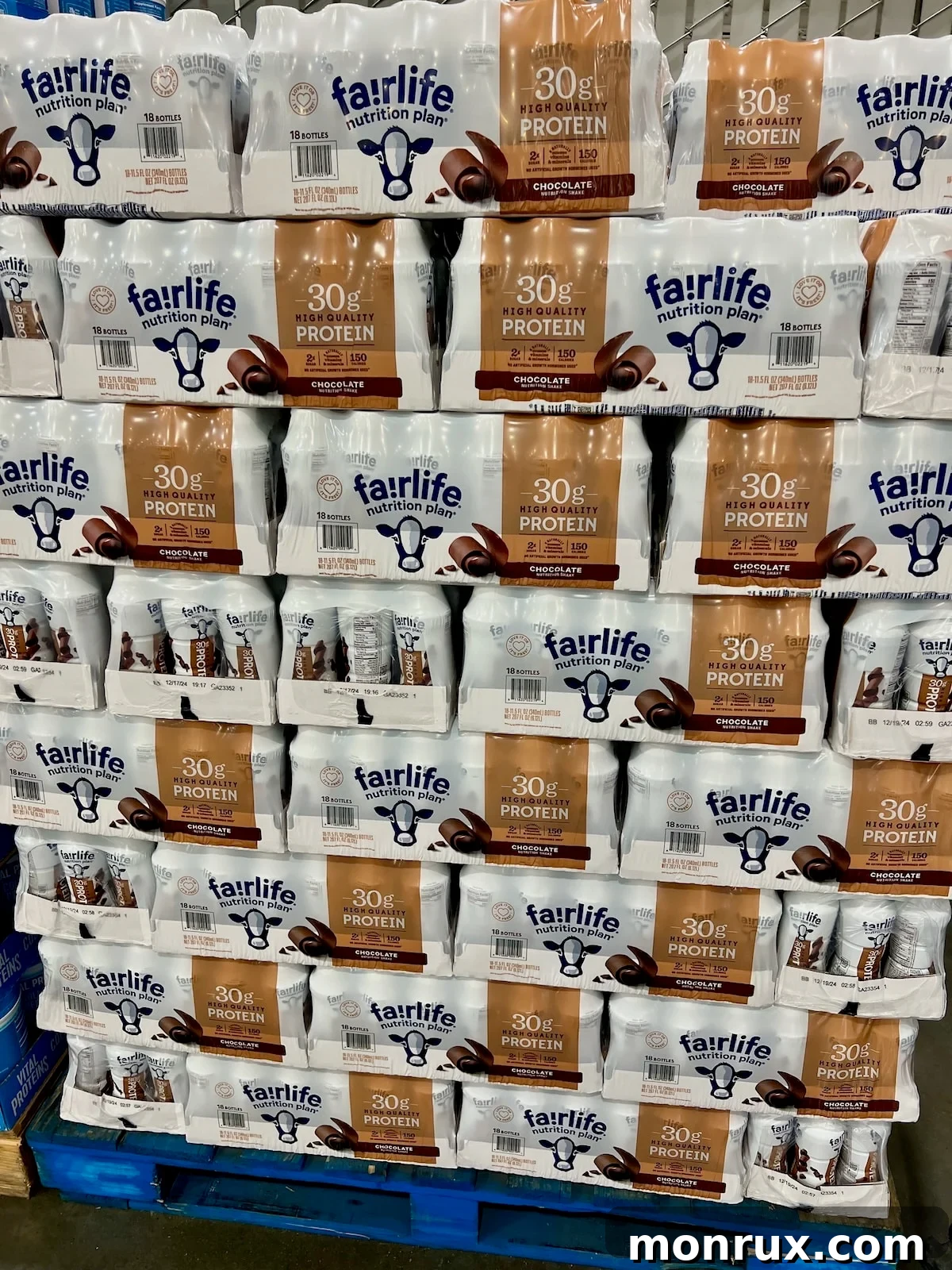 Fairlife protein shakes displayed on a pallet at Costco, indicating their widespread availability and popularity.