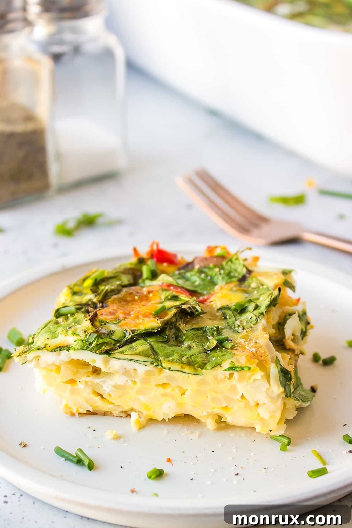 a slice of dairy-free breakfast casserole on white plate.