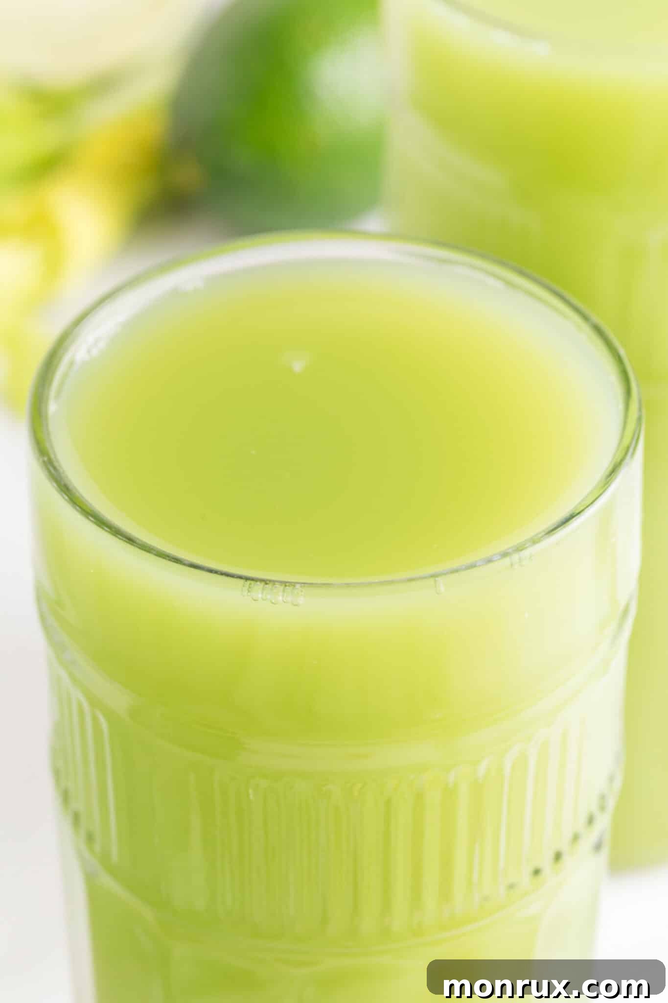 glass of fresh celery juice on table.