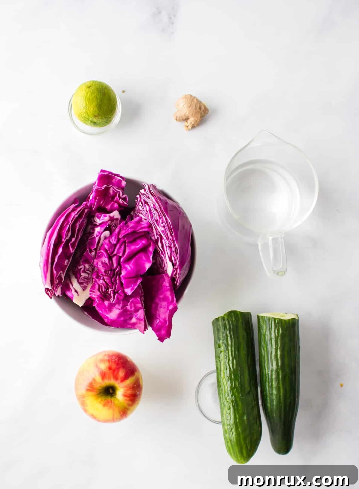 Ingredients for making red or purple cabbage juice laid out on a cutting board.