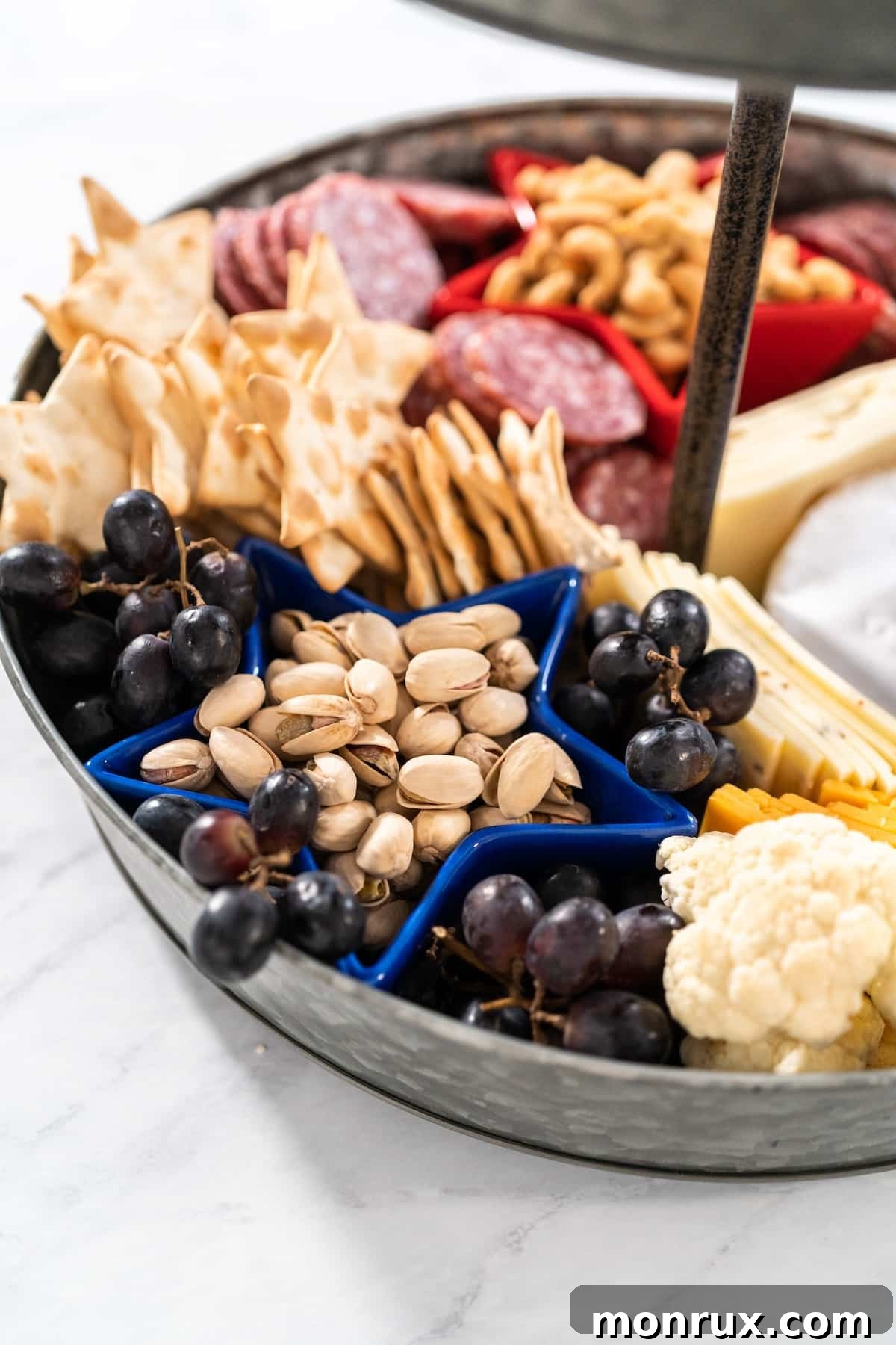 A close-up view of the 4th of July charcuterie board, highlighting the colorful assortment of fruits, nuts, and crackers.