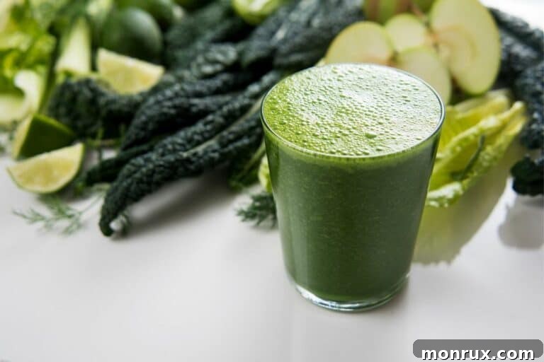 A glass of vibrant green juice on a white counter, perfectly illustrating the refreshing and healthy beverage.