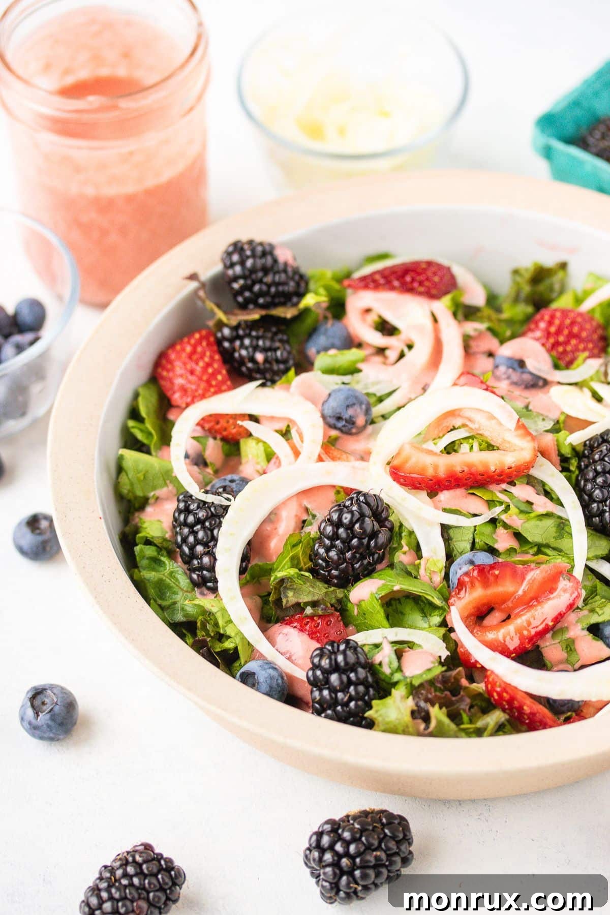 A vibrant, colorful summer salad adorned with fresh berries, artfully arranged on a rustic wooden table, evoking a sense of healthy indulgence and seasonal freshness.
