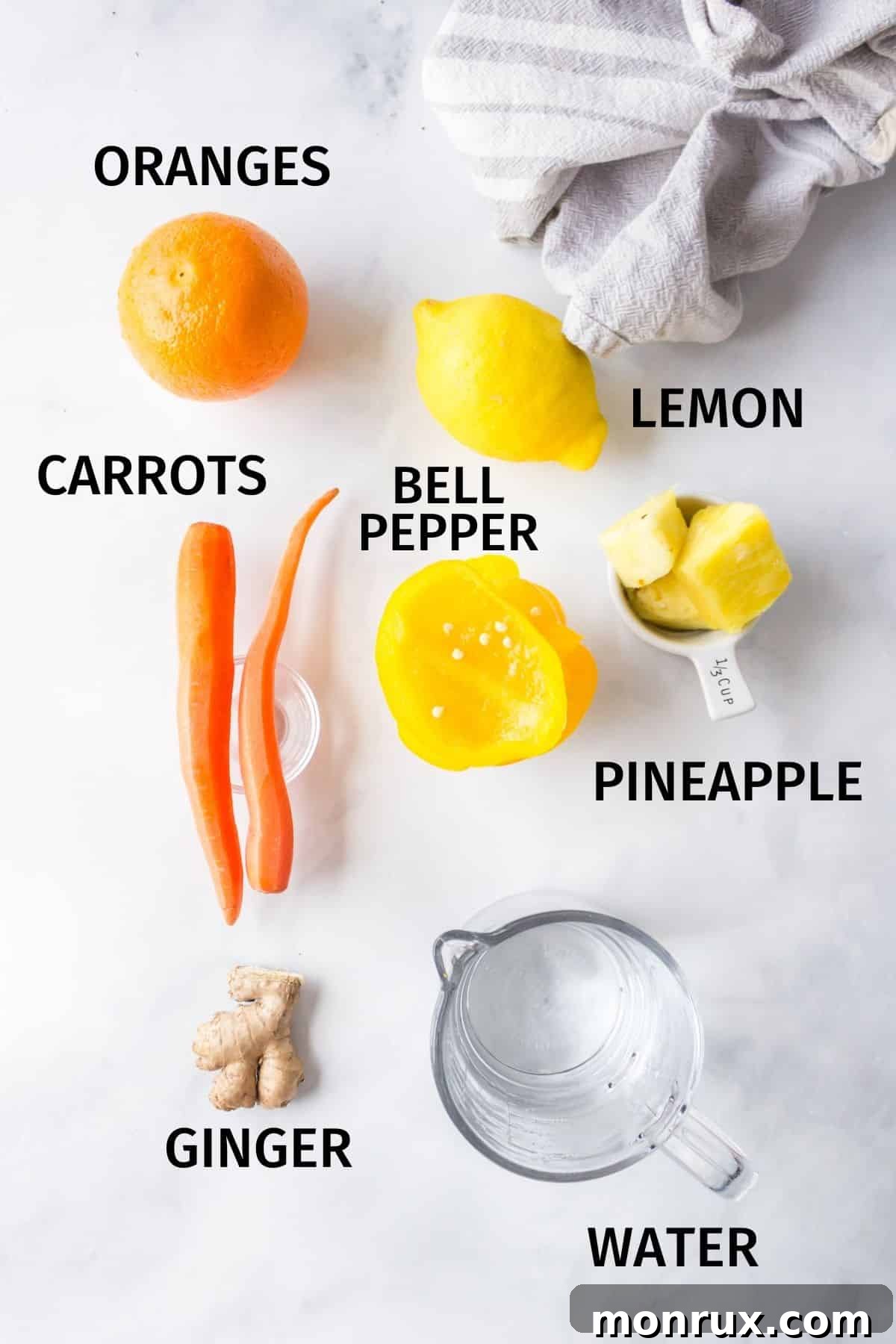 A collection of fresh, colorful ingredients laid out on a kitchen counter, ready for making healthy yellow juice.