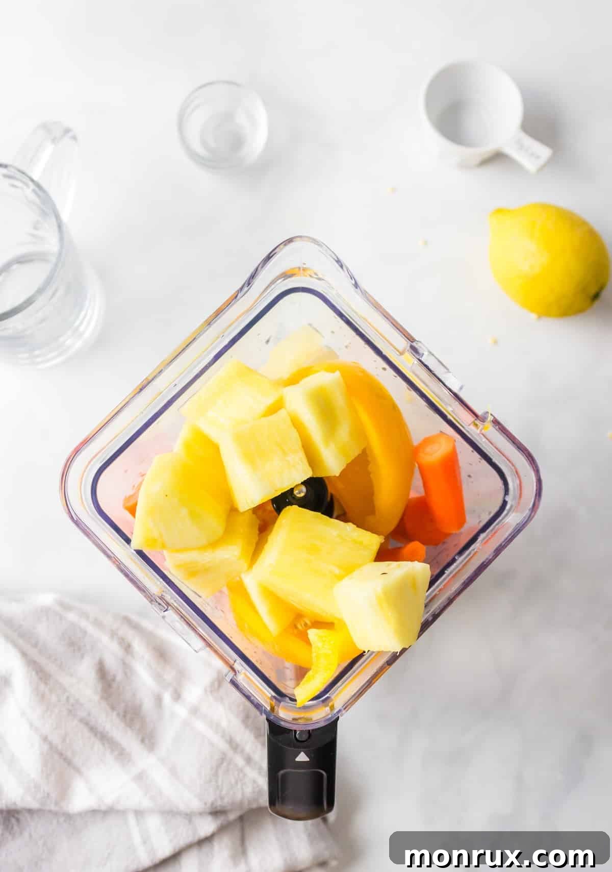 All yellow juice ingredients are placed inside a blender, ready to be processed.