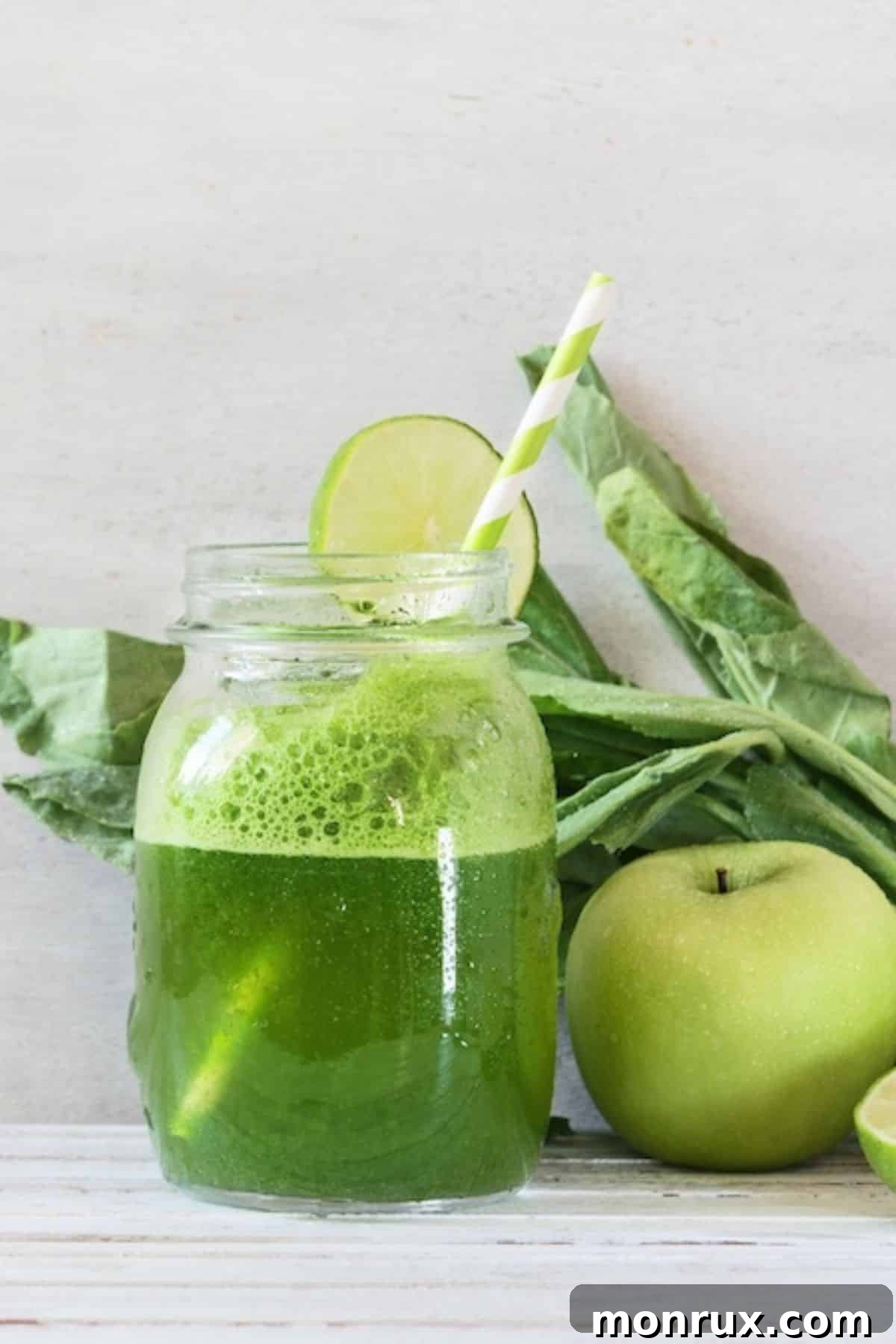 A refreshing glass of dandelion green juice with a straw, perfect for a healthy start.