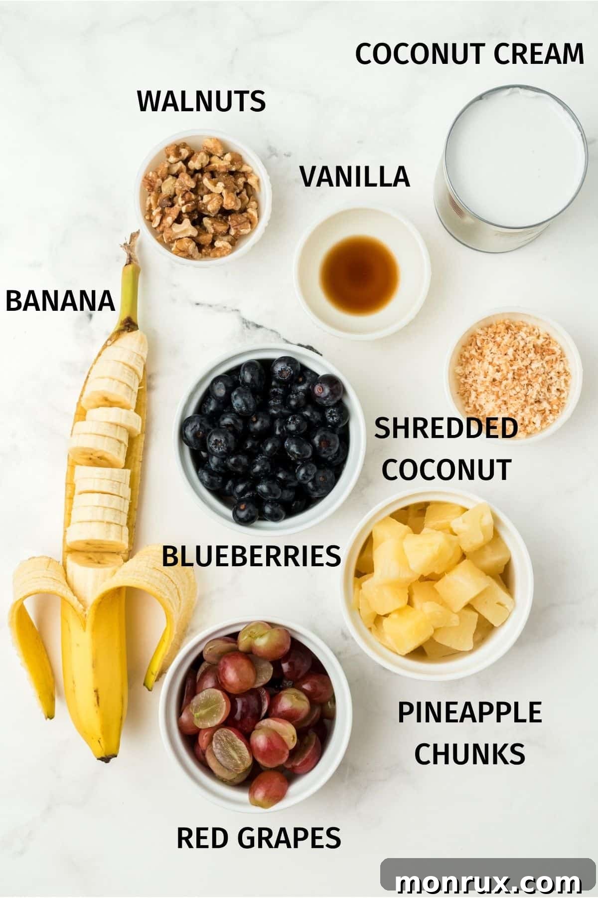 A flat lay photograph displaying the fresh and natural ingredients required for making a healthy ambrosia salad.