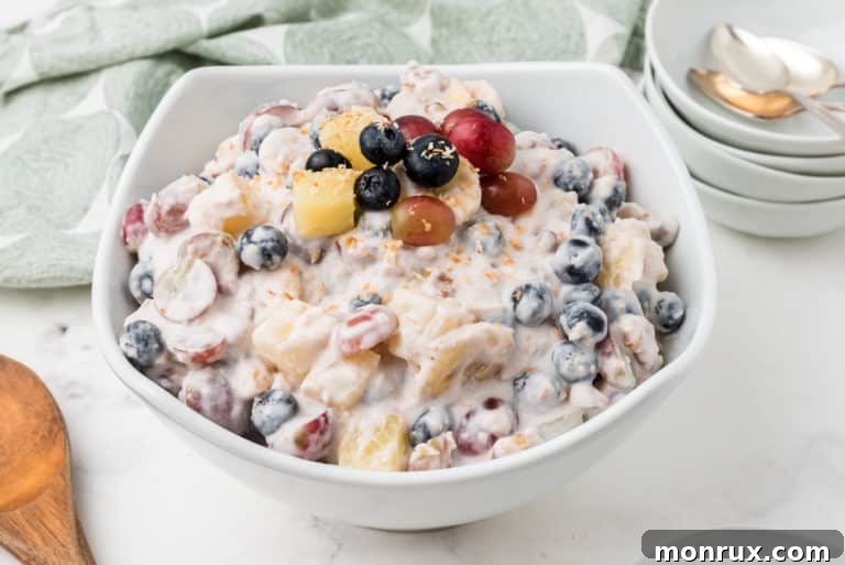 A bowl of creamy and colorful vegan ambrosia salad, ready for serving.