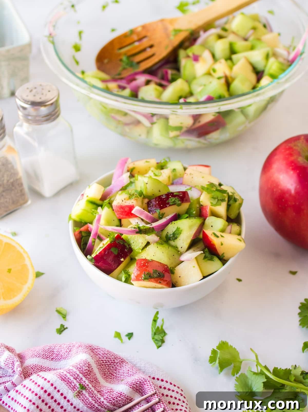 cucumber apple salad with serving bowl.
