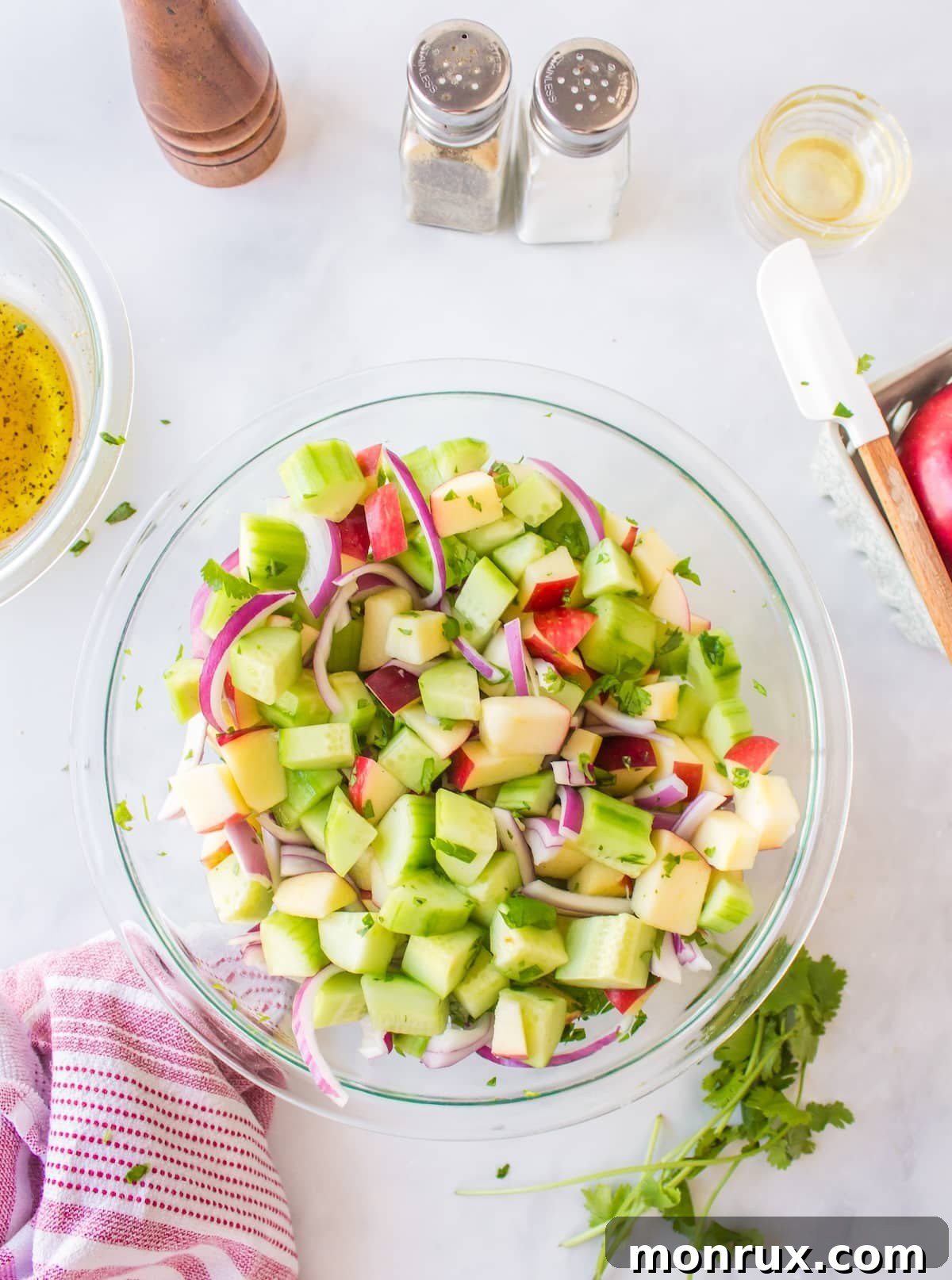 salad ingredients in bowl tossed with salad dressing.
