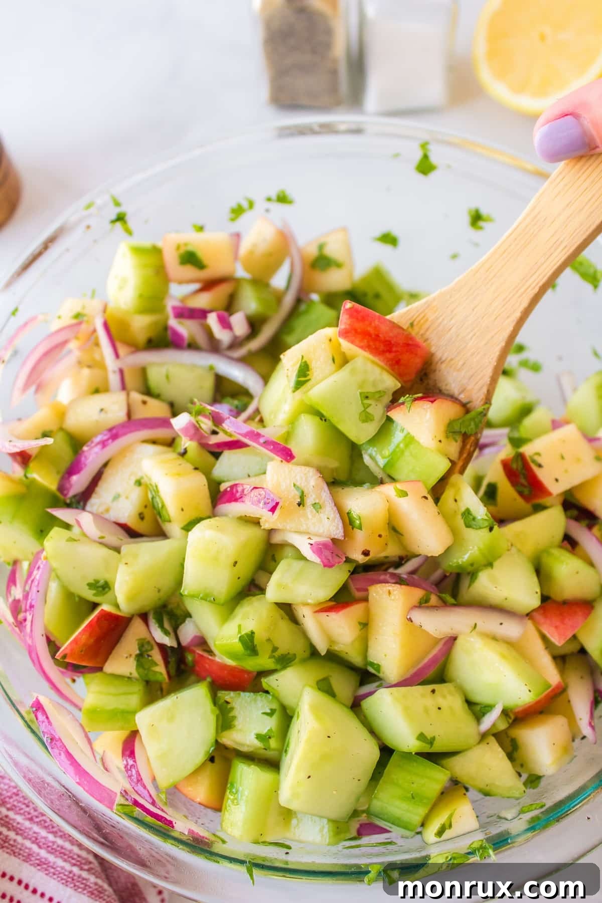 ingredients for salad in bowl with serving spoon.
