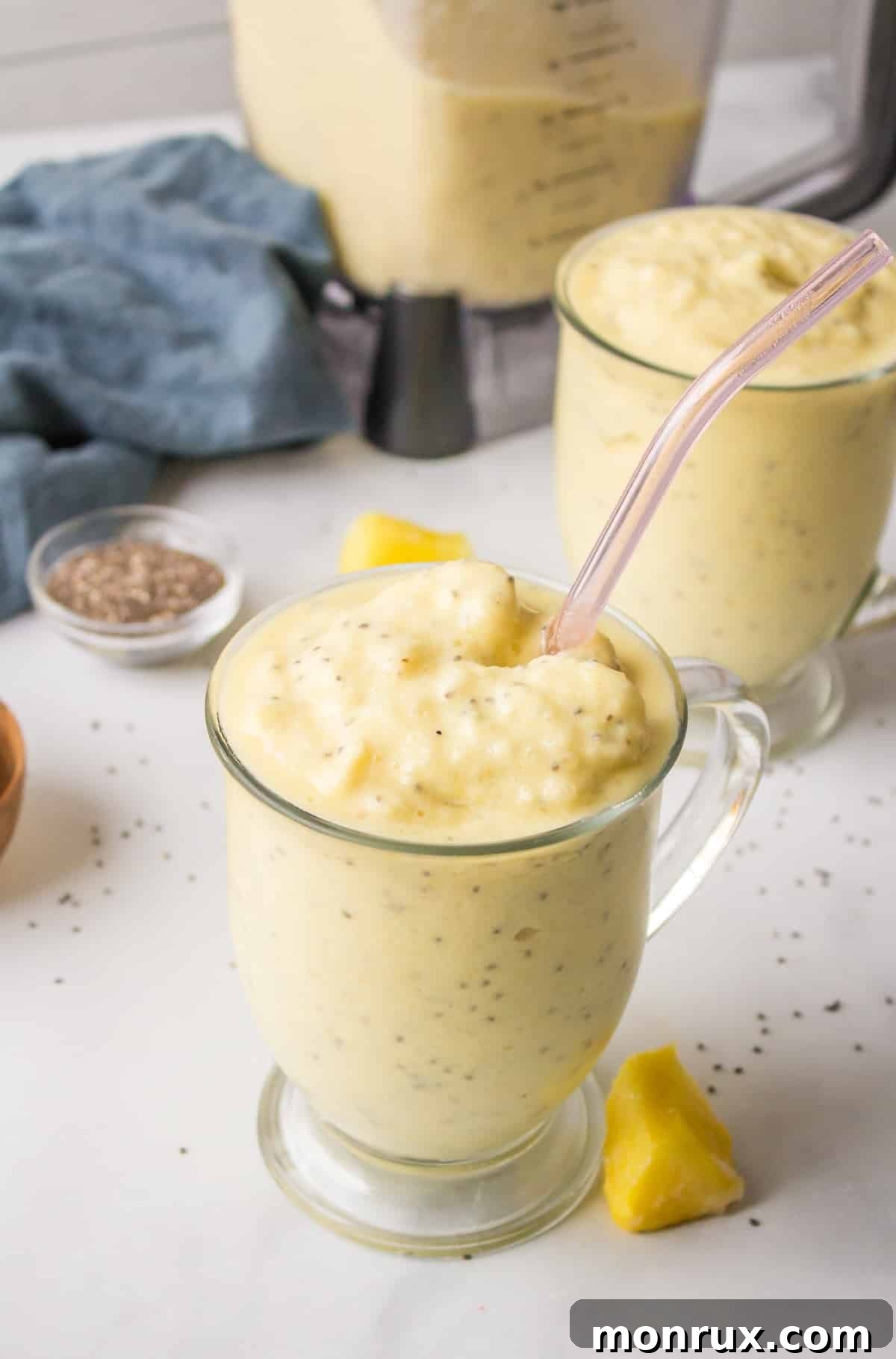Refreshing pineapple smoothie in a clear glass, garnished with a pineapple slice and a straw, promoting weight loss.