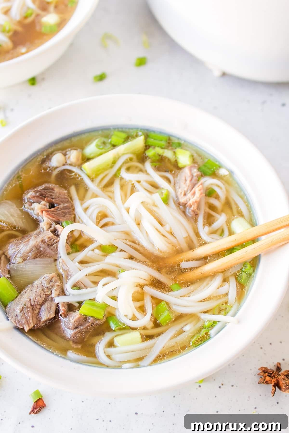 Hearty slow cooker beef pho with perfectly cooked rice noodles, ready to be enjoyed.
