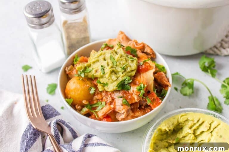 slow cooker chicken and potatoes with guacamole, served in a bowl.