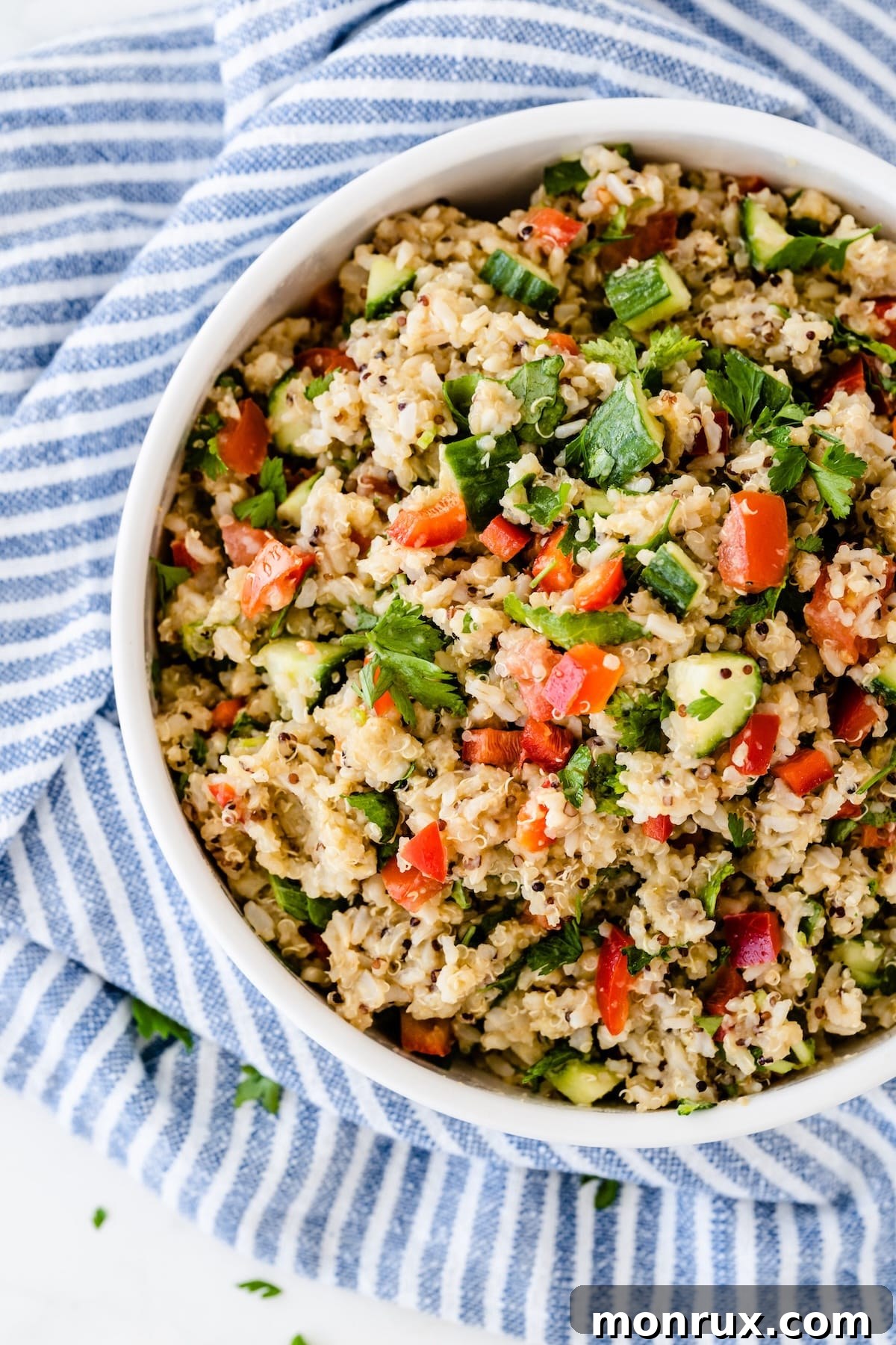 A vibrant bowl of quinoa salad, packed with colorful vegetables, ready for a party table.